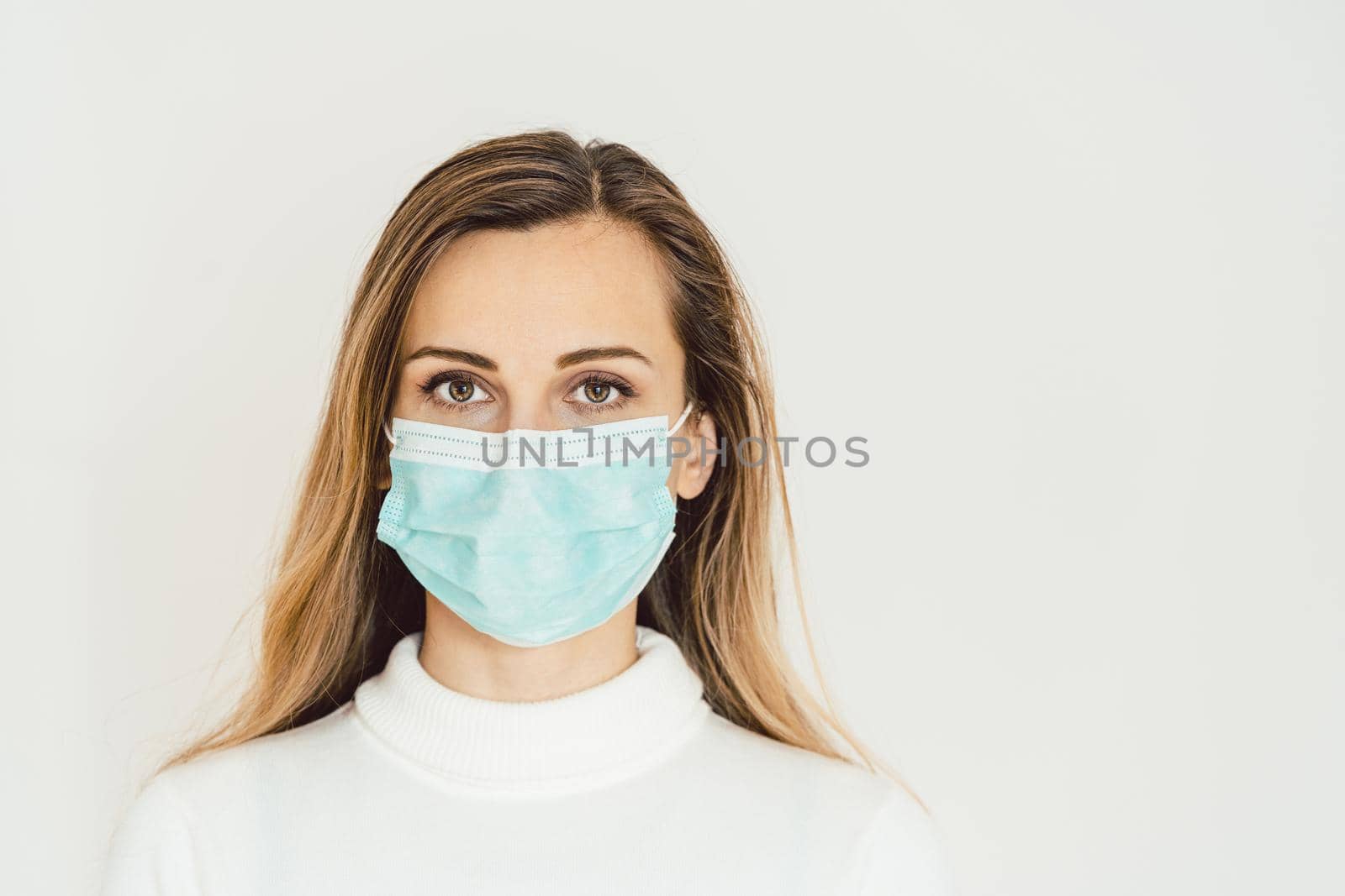 Woman with corona mask protecting her from Covid-19 staying at home in quarantine