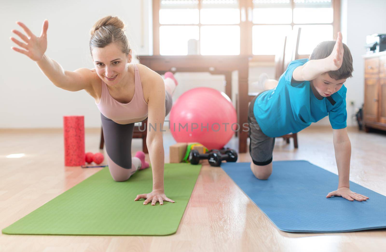 Mother and son in coronavirus quarantine having fitness workout at home