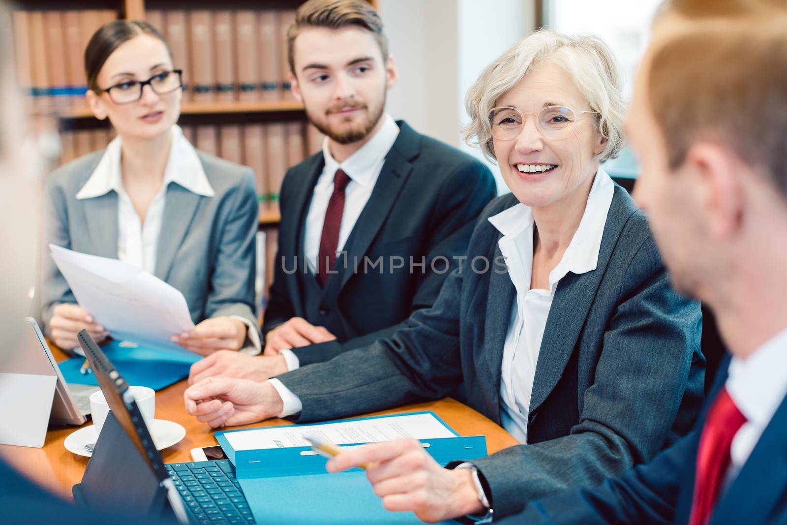 Business team working on some exciting project with computers and documents