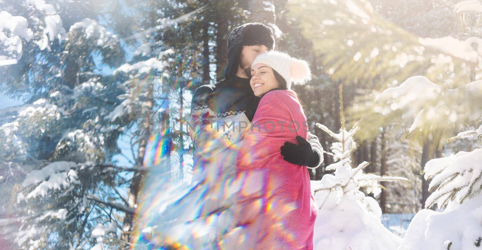 Happy romantic couple standing in snowy background