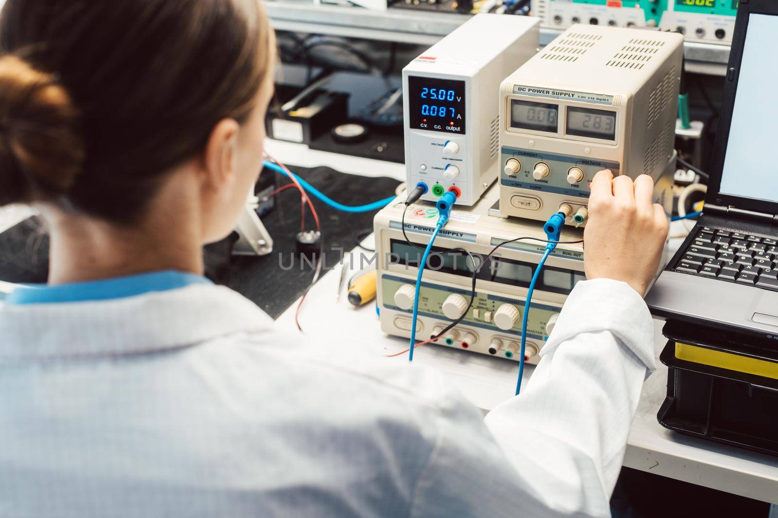 Engineer woman in electronics lab testing EMC compliance of a product