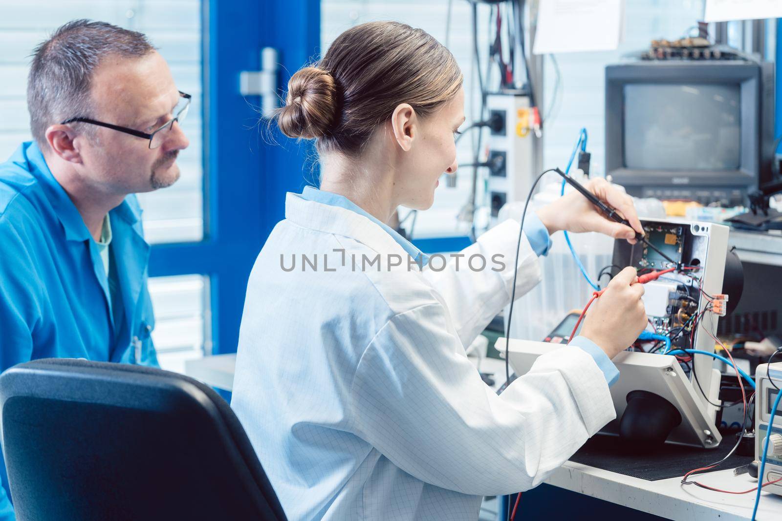 Team of electronic engineers testing a product prototype on test bench in the lab