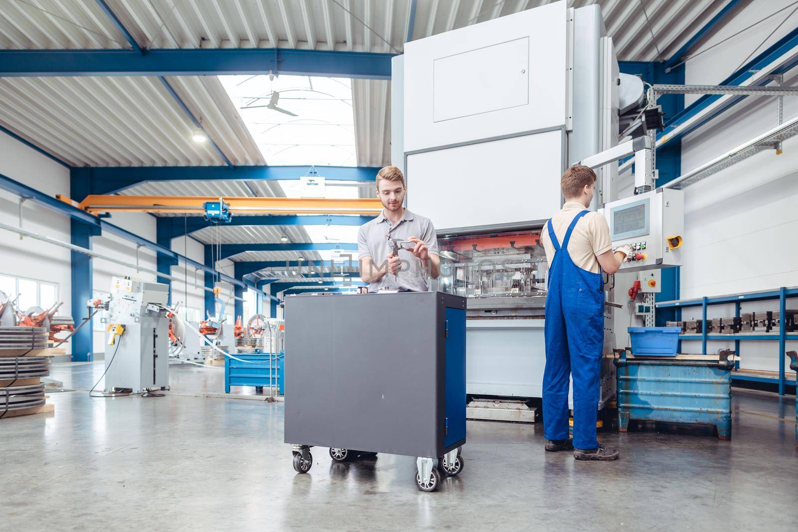 Manufacturing workers on the factory floor being industrious for the metal industry