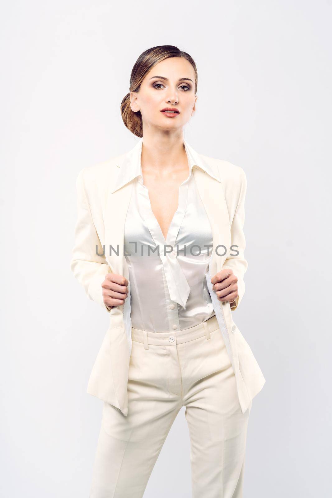 Elegant and fashionable business woman in a white suit by Kzenon