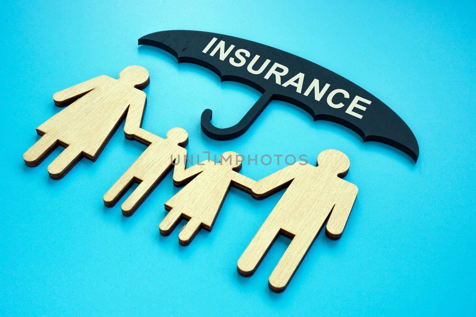 Life insurance concept. An umbrella over the family.