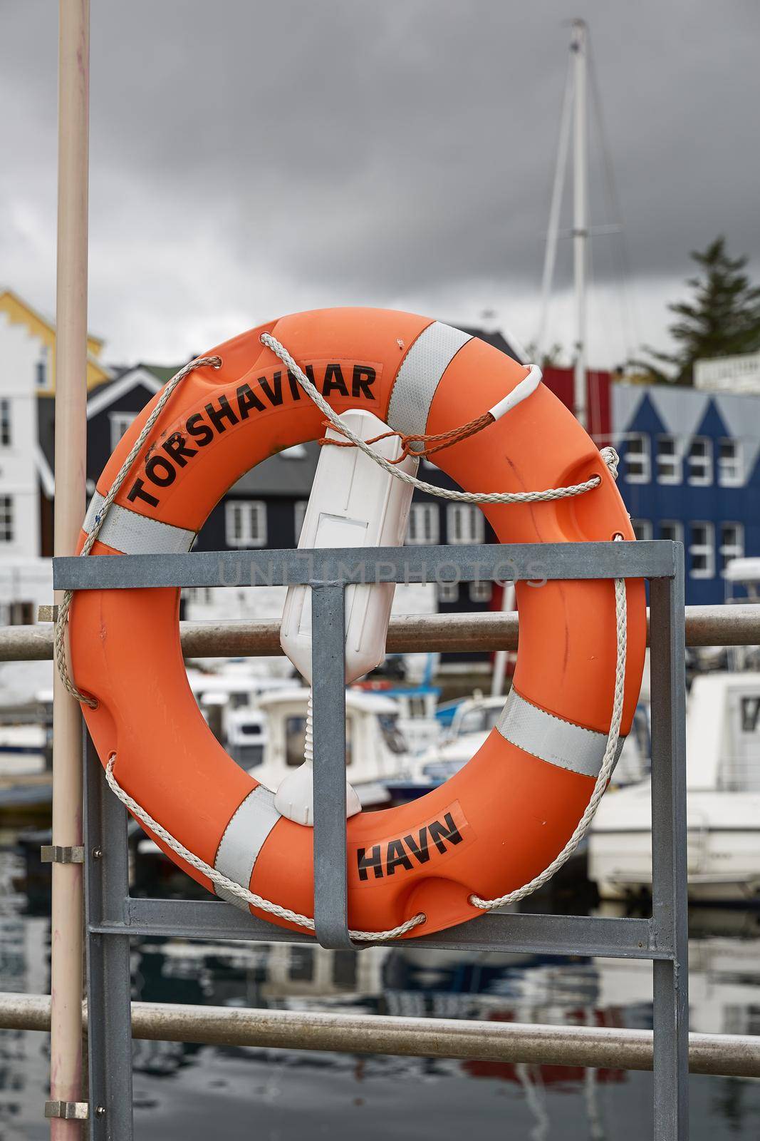 Lifering in port area with name of town of Torshavn, Faroe Islands, Denmark written on it.