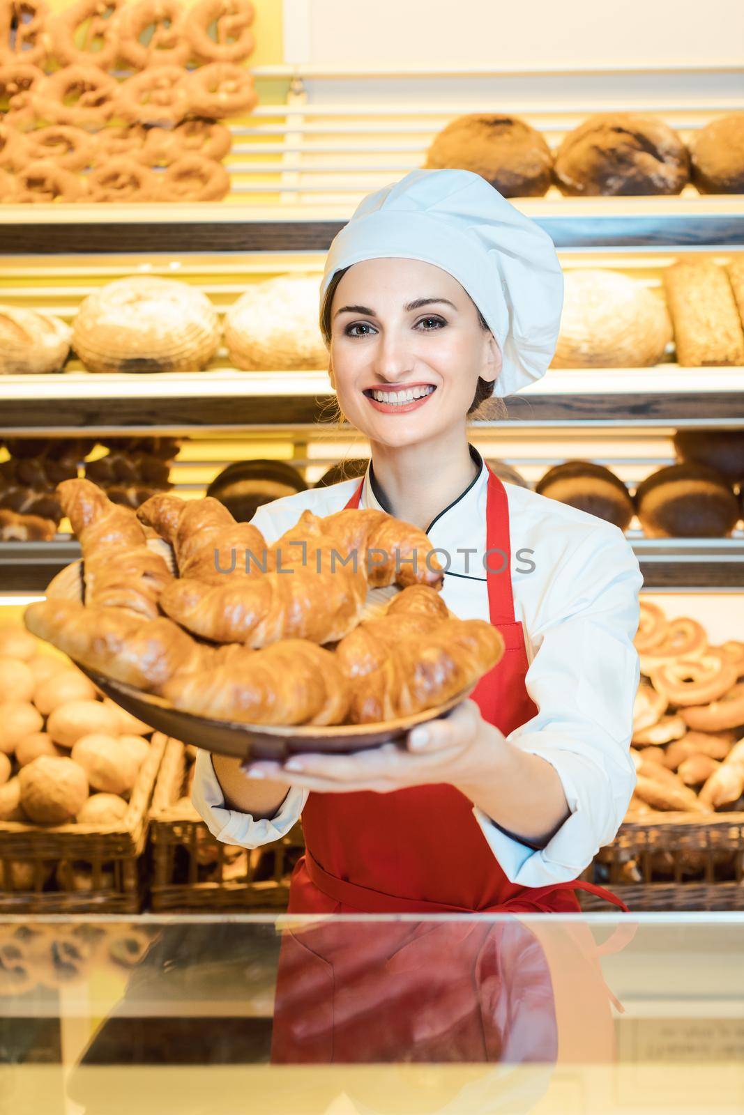Sales woman offering fresh pastries in a basket