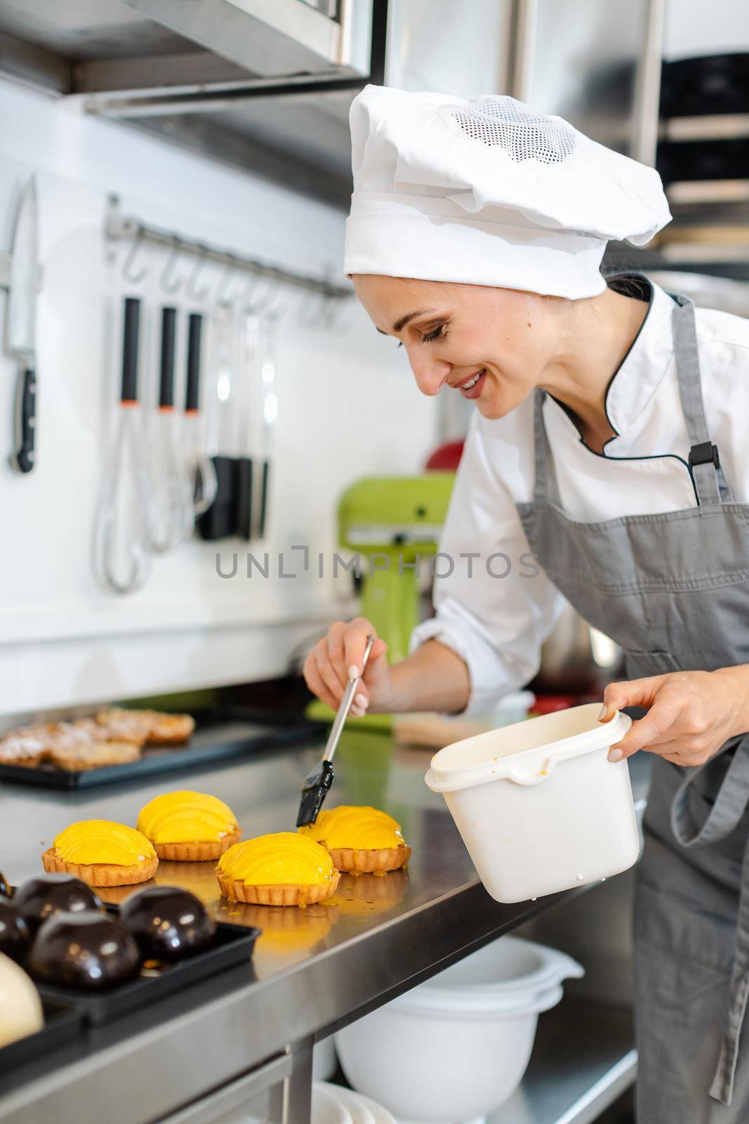 Absorbed confectioner working on sweet little cakes