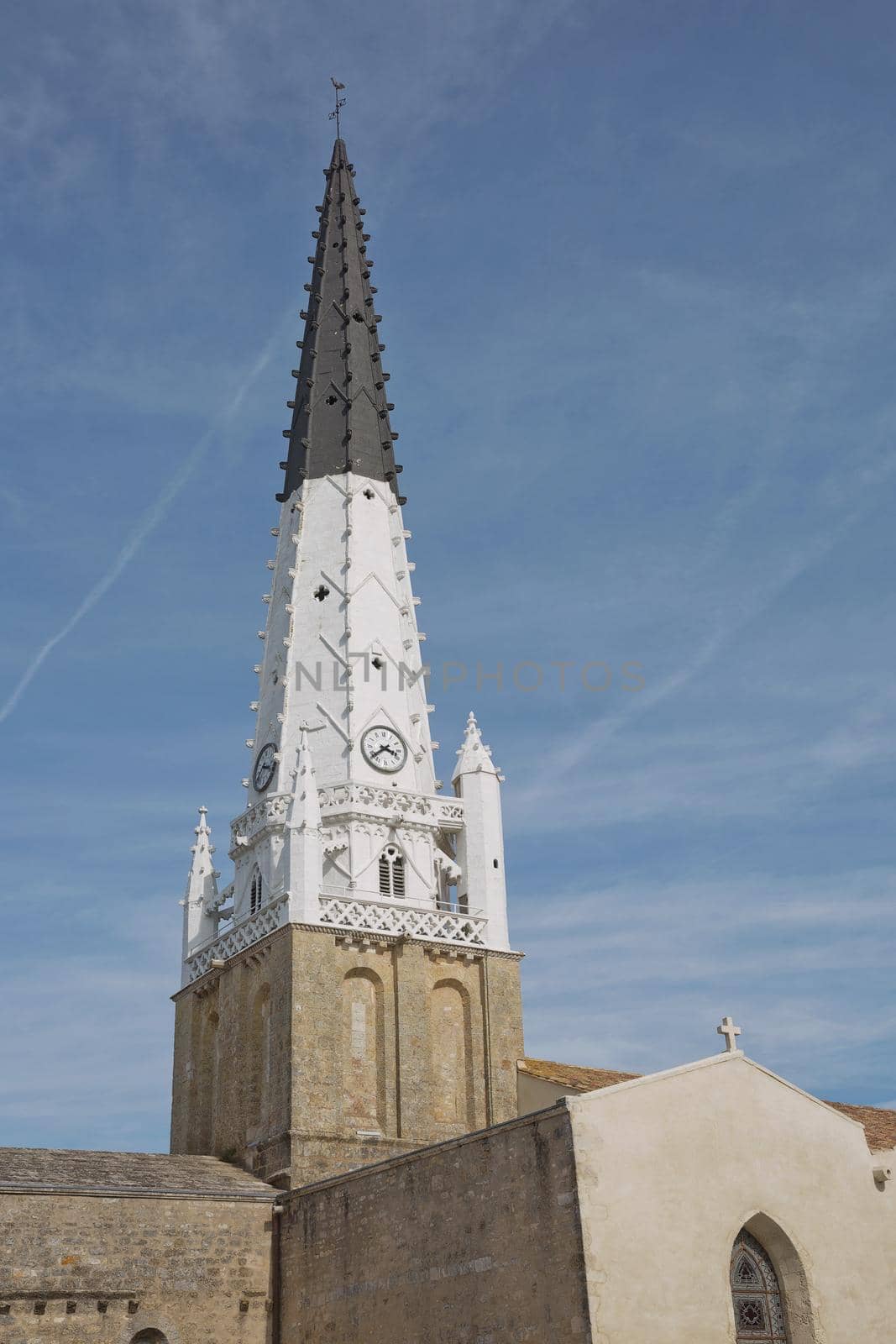 Church of Ars with black and white bell tower in the Ile de Re in Charente France.