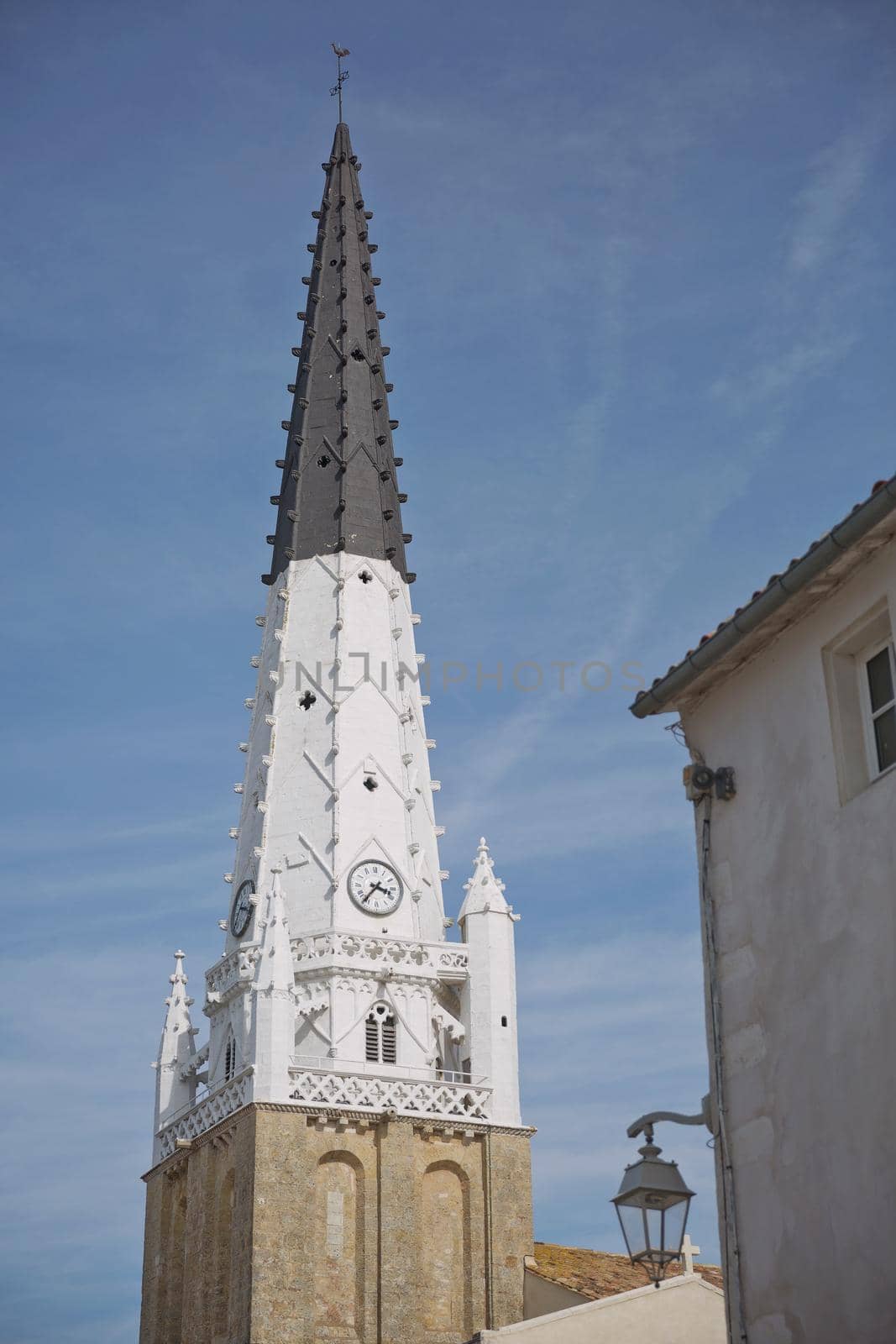 Church of Ars with black and white bell tower in the Ile de Re in Charente France.