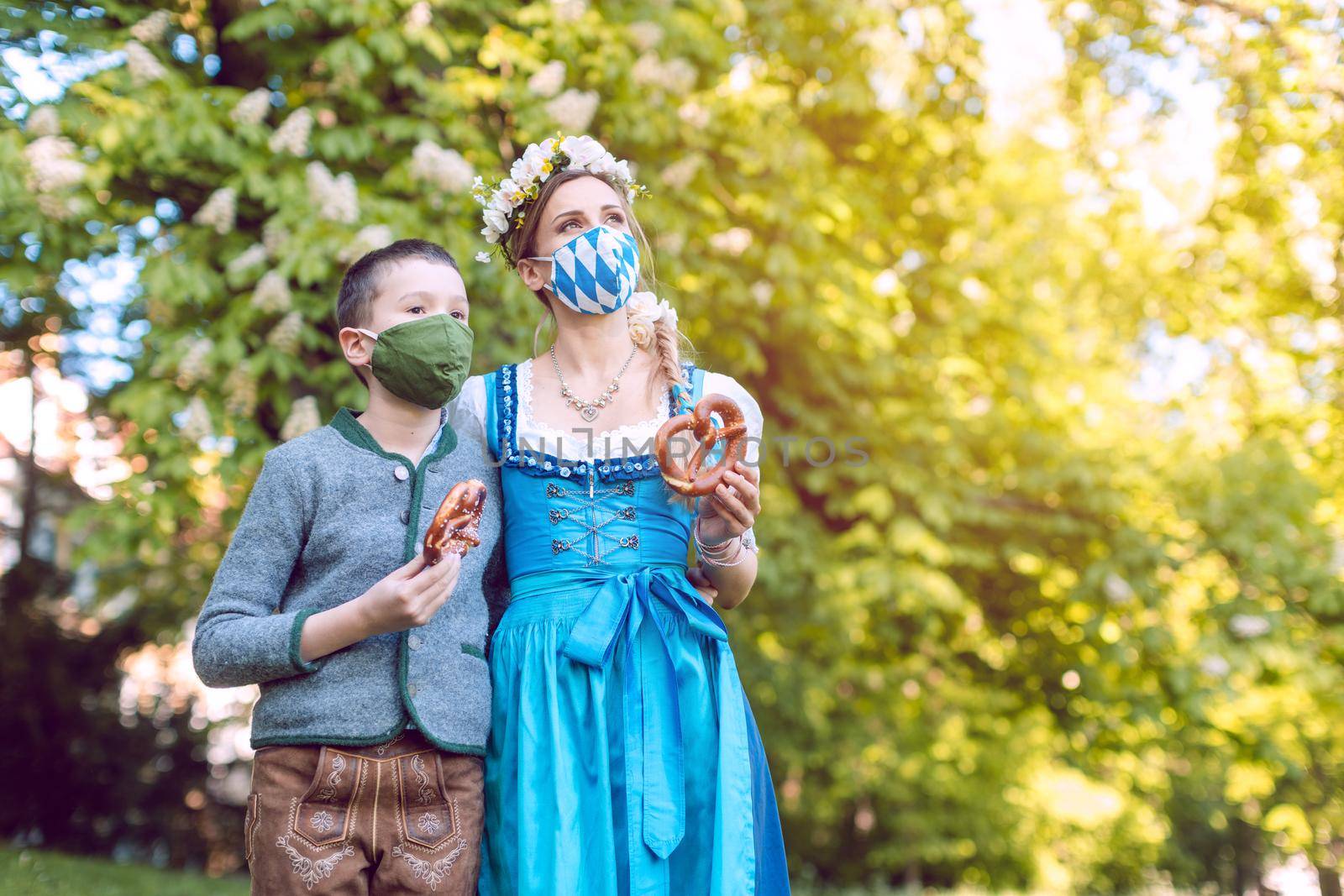 Bavarian family during the coronavirus crisis standing under a chestnut tree