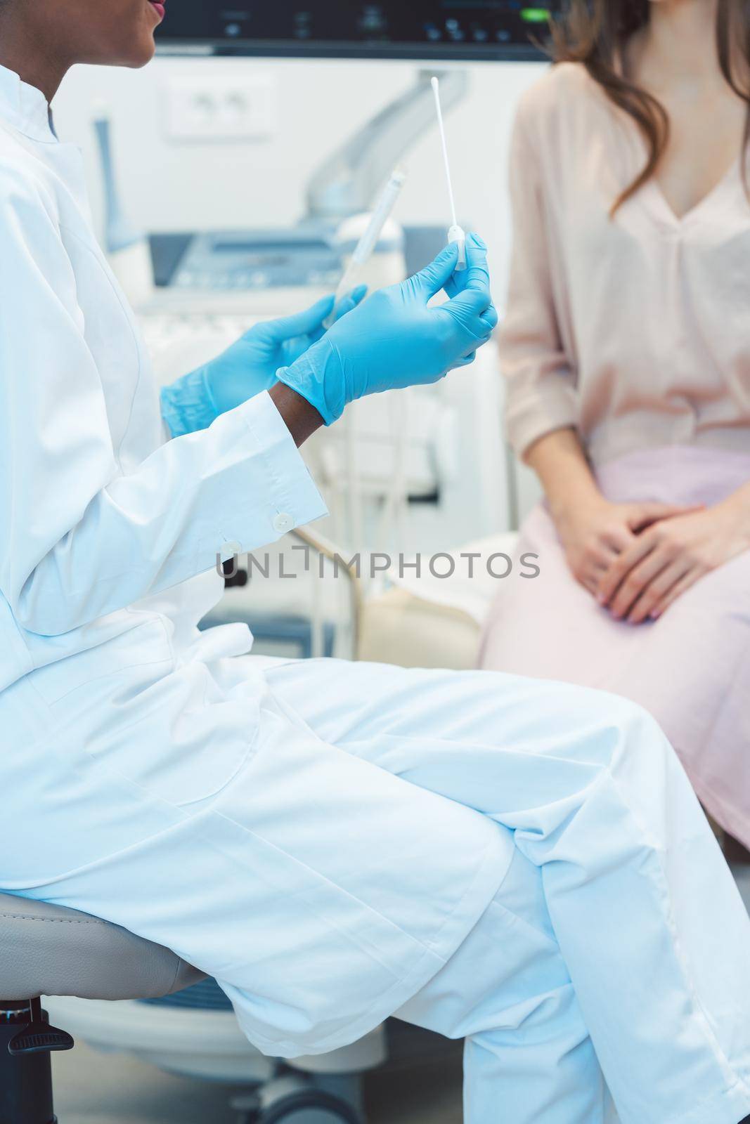 Gynecologist testing vaginal swab for STD, close-up