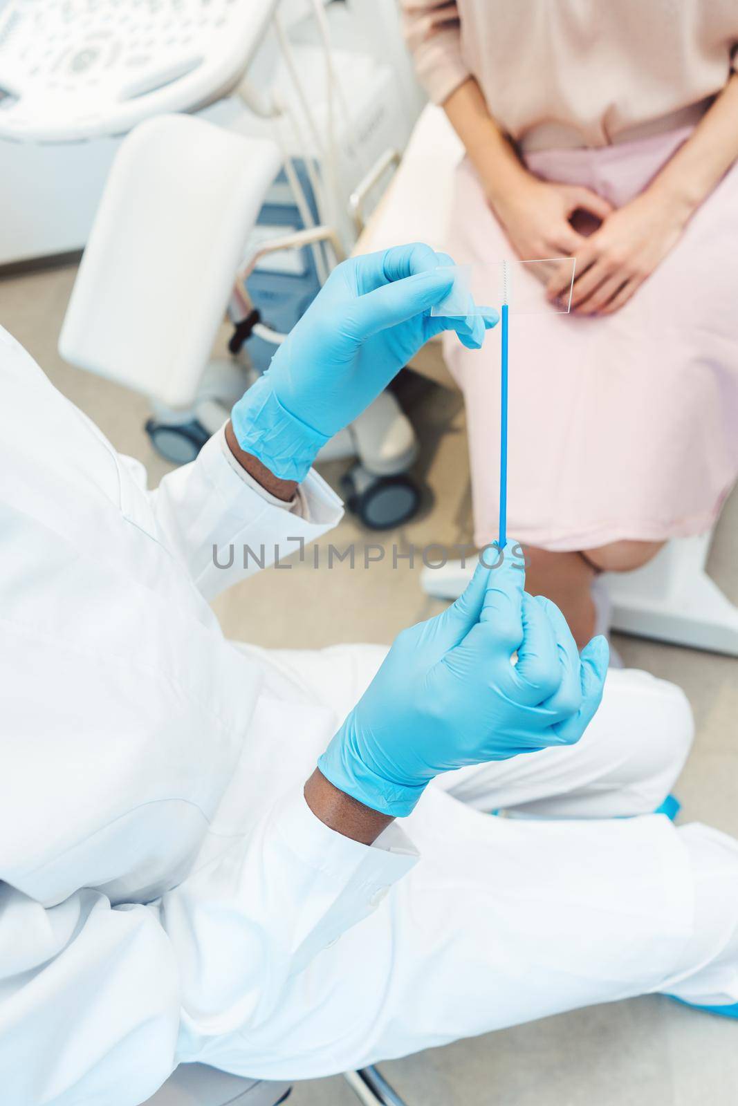 Close-up of woman having test for sexually transmitted disease with doctor