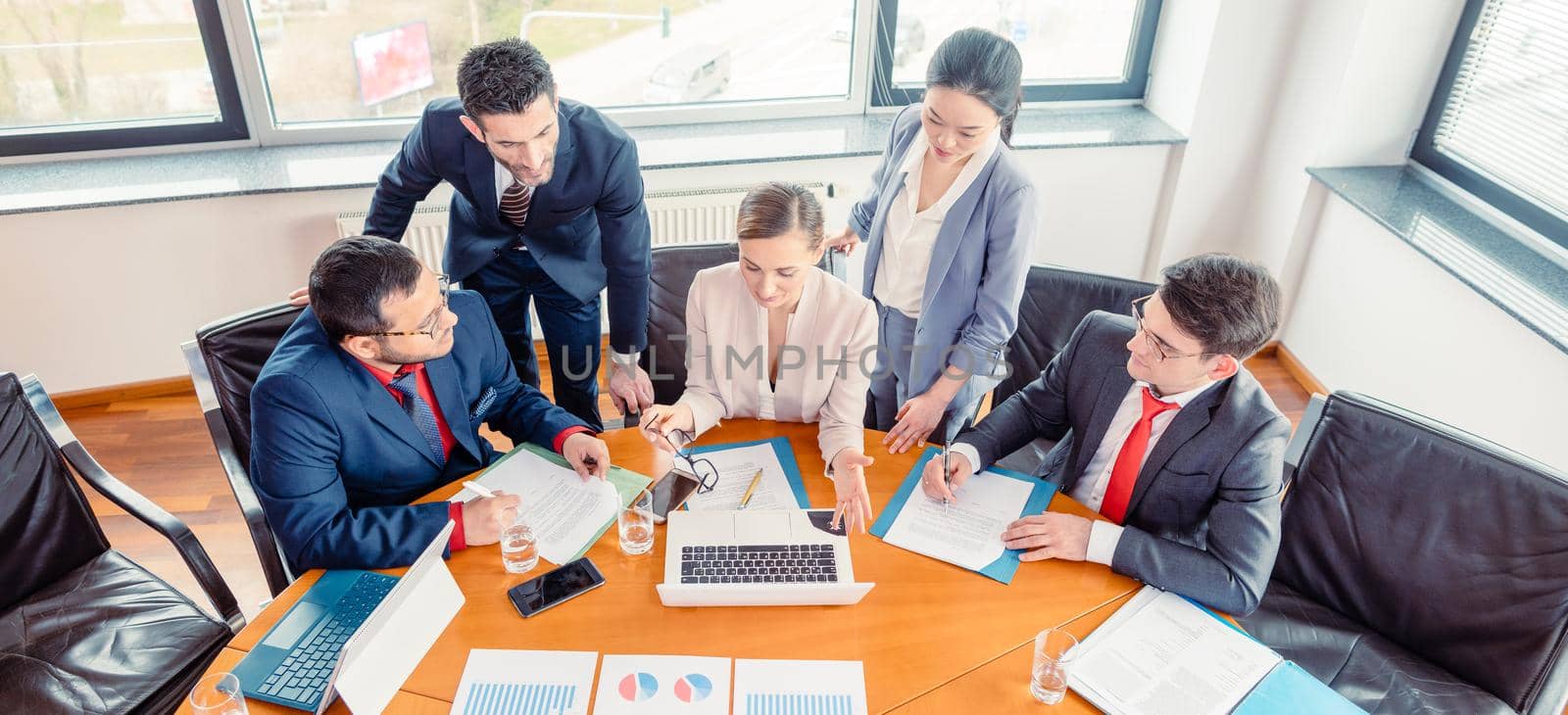 Five business people in a project meeting working together