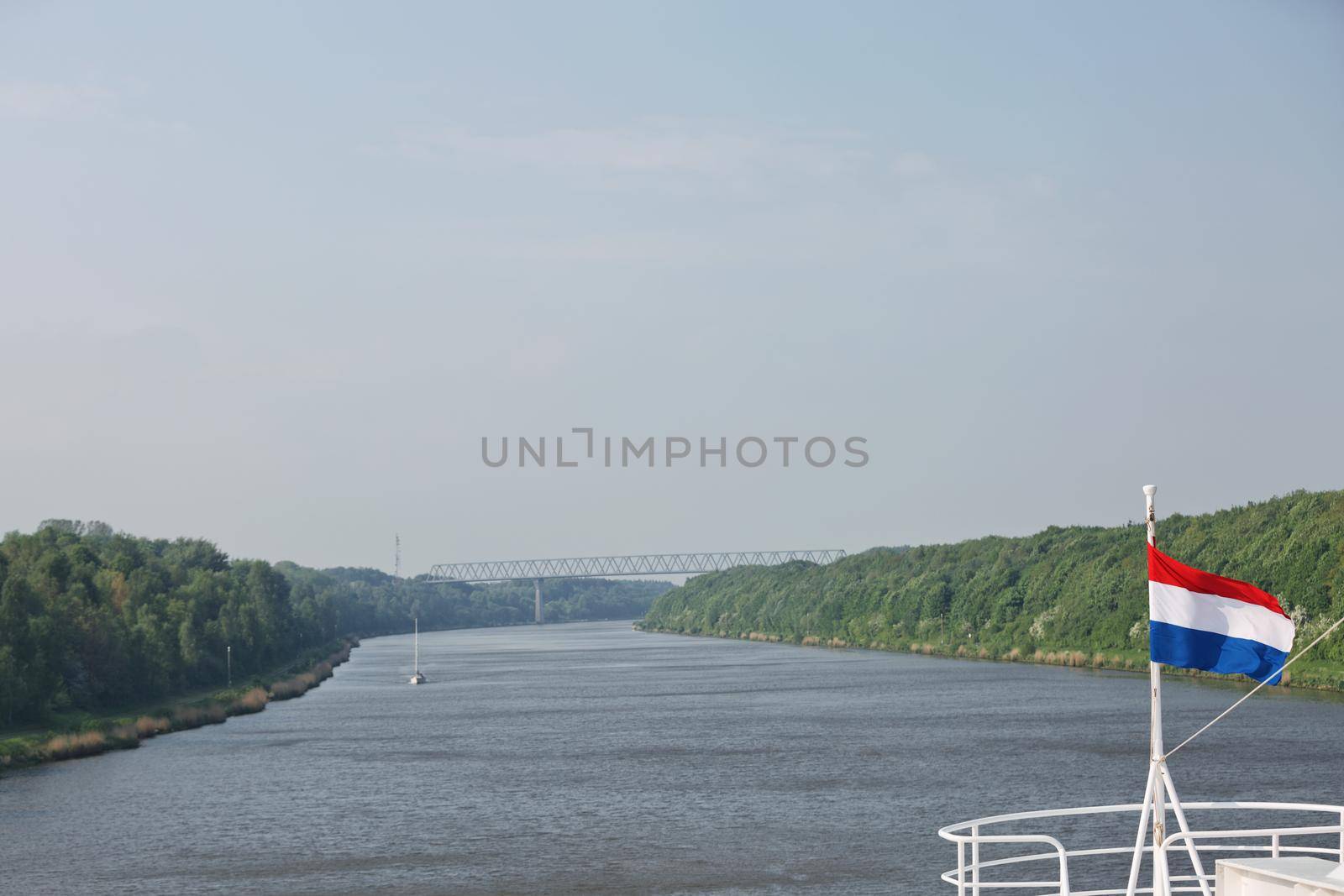 Cruise ship sailing through Kiel canal in Germany. The Kiel Canal goes through the middle of Schleswig-Holstein and it is 98 km long.