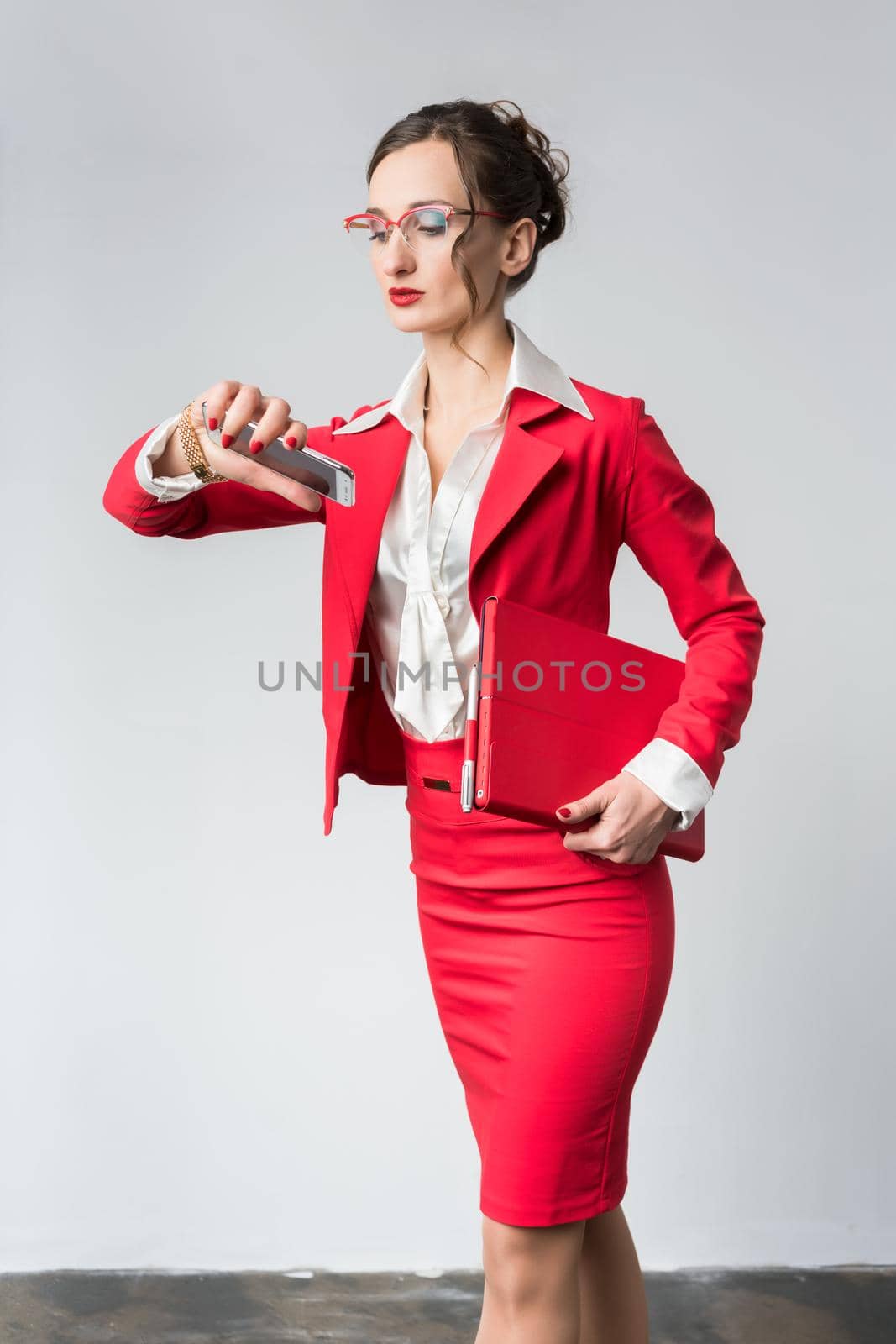 Businesswoman being late to her meeting checking the time on wristwatch