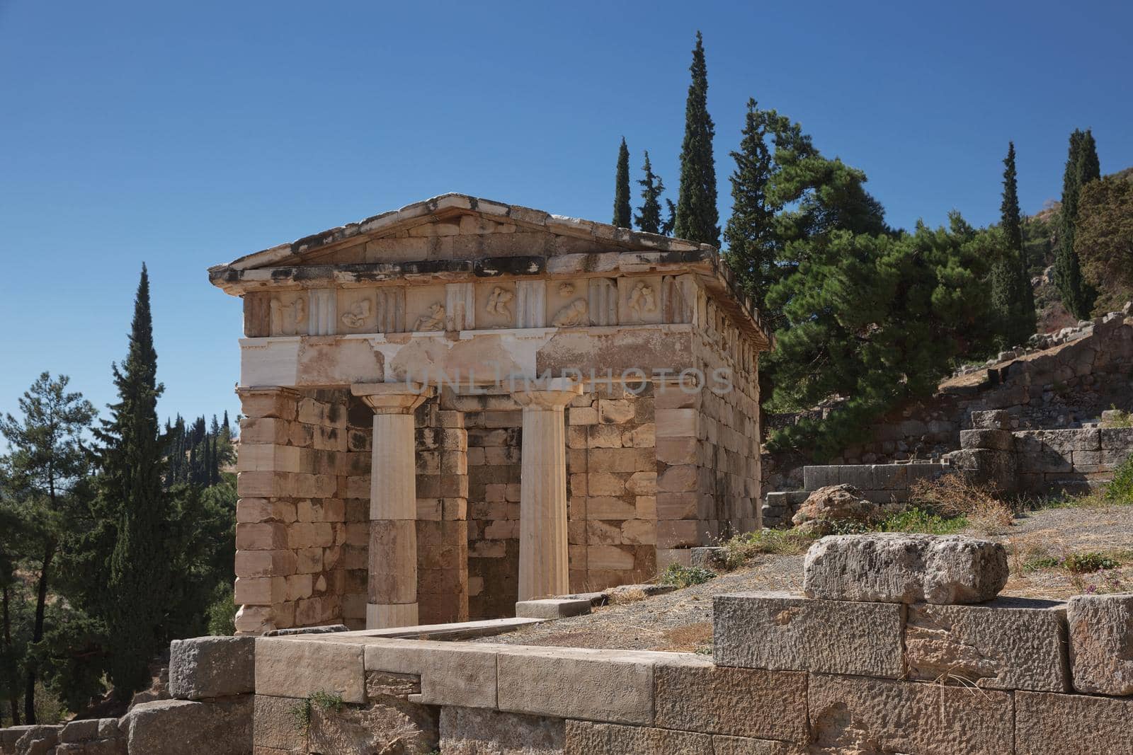 Athenian Treasure in Delphi, Greece, ancient sanctuary that grew rich as seat of oracle that was consulted on important decisions throughout ancient classical world. UNESCO World heritage.