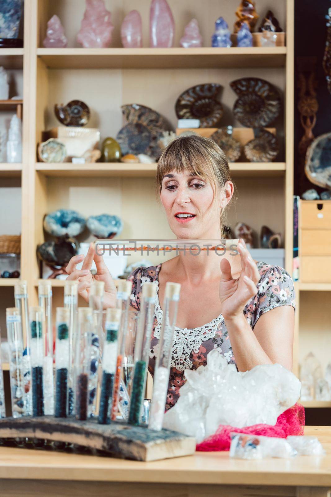 Young woman working with gemstones as a hobby in her workshop