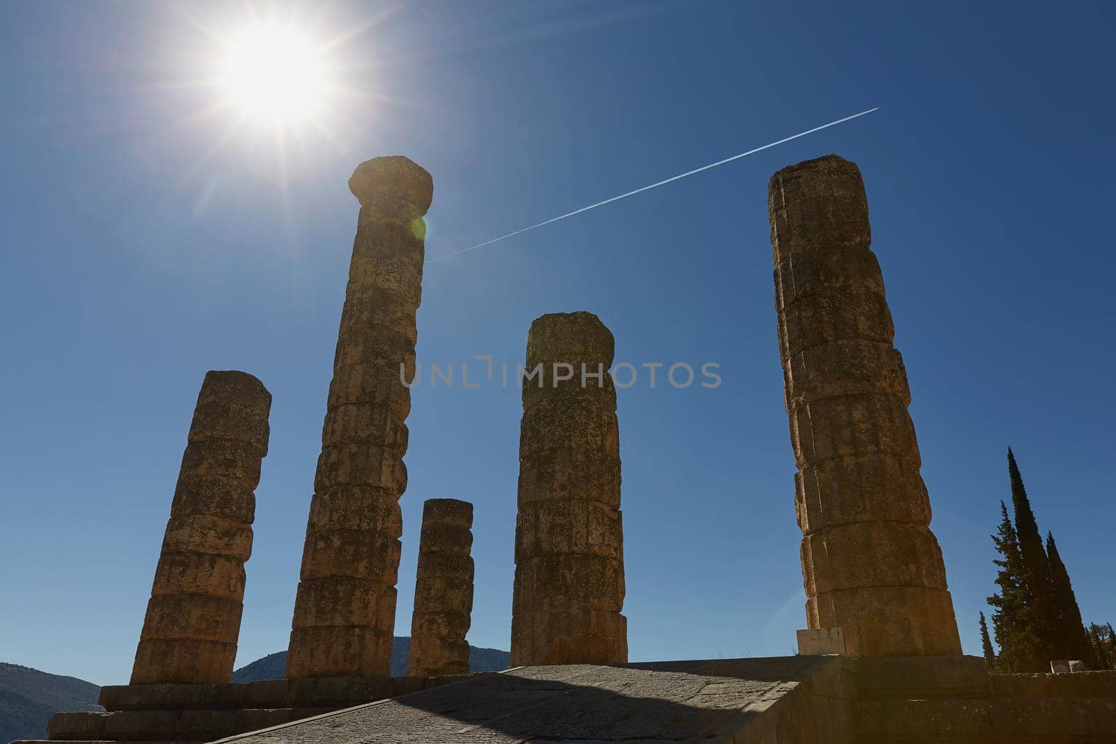 Low Angle View of The Temple of Apollo at Delphi, Greece with Sun Star Effect