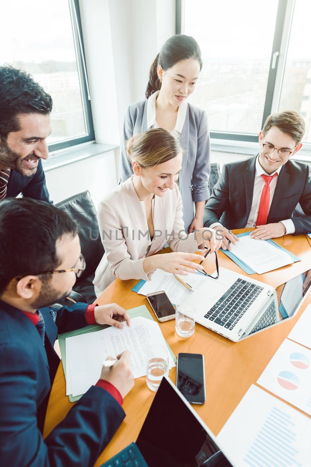 Five business people in a project meeting working together