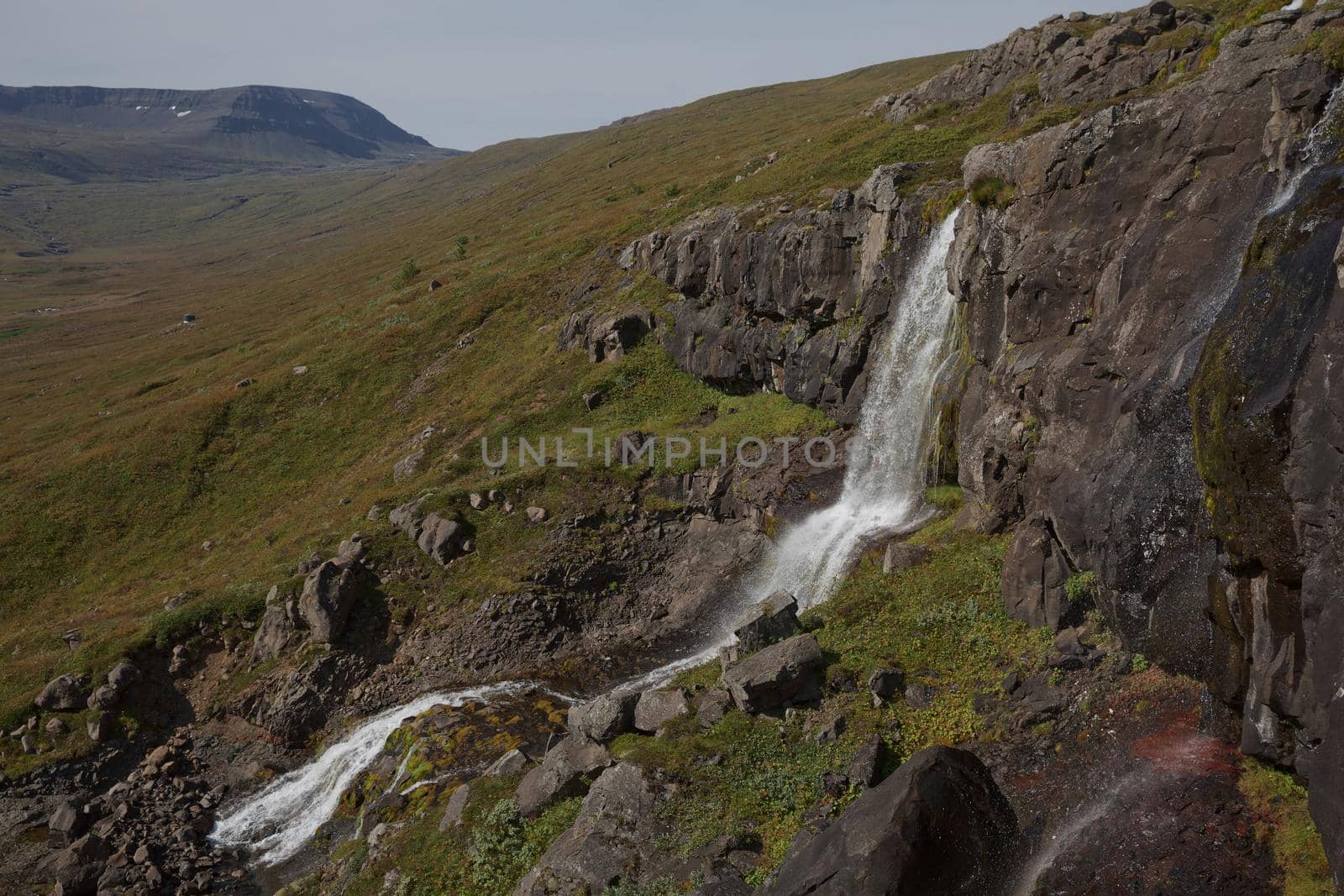 Beautiful cascade waterfall Bleiksarfoss in Eskifjordur, east of Iceland.