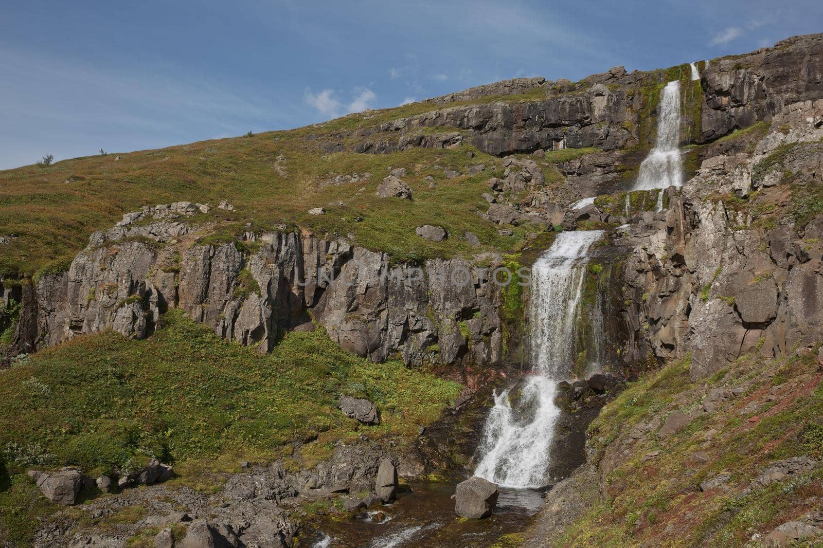 Beautiful cascade waterfall Bleiksarfoss in Eskifjordur, east of Iceland.