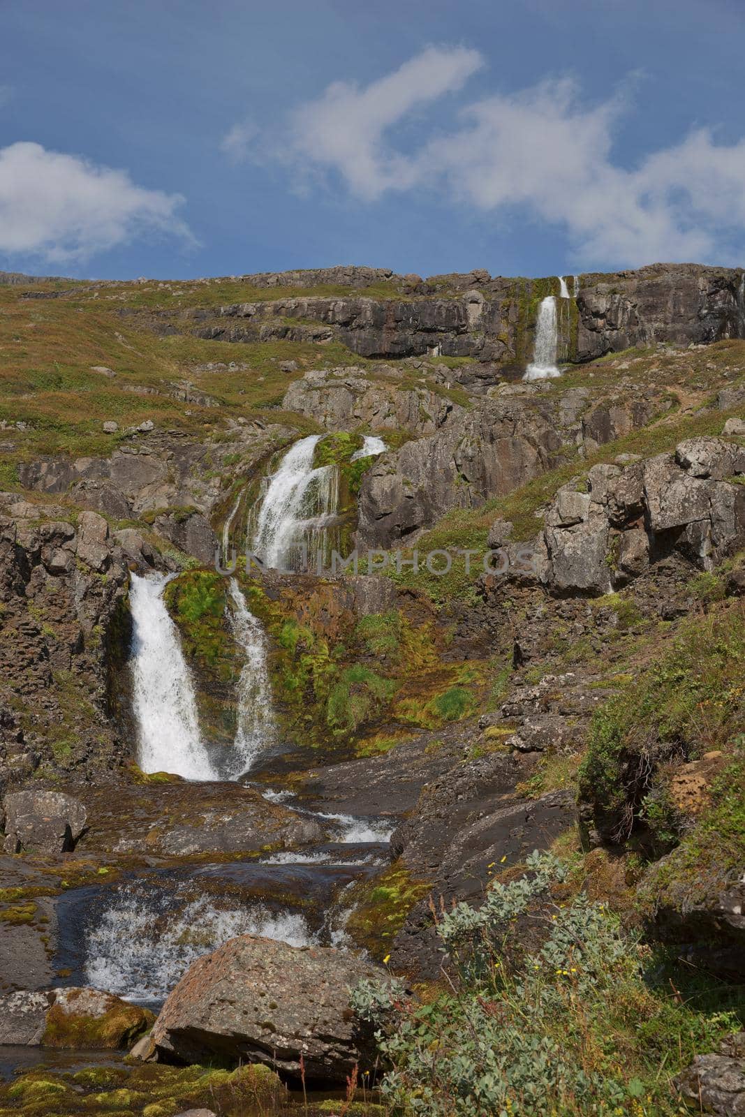 Beautiful cascade waterfall Bleiksarfoss in Eskifjordur, east of Iceland.