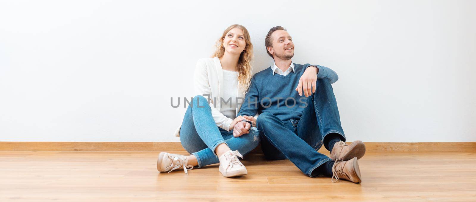 Couple dreaming about their future in the new apartment by Kzenon