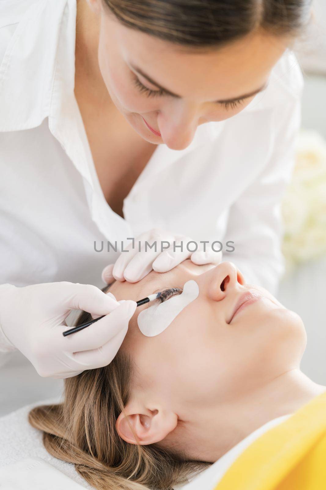 Woman having her lashes thickened and extended in salon