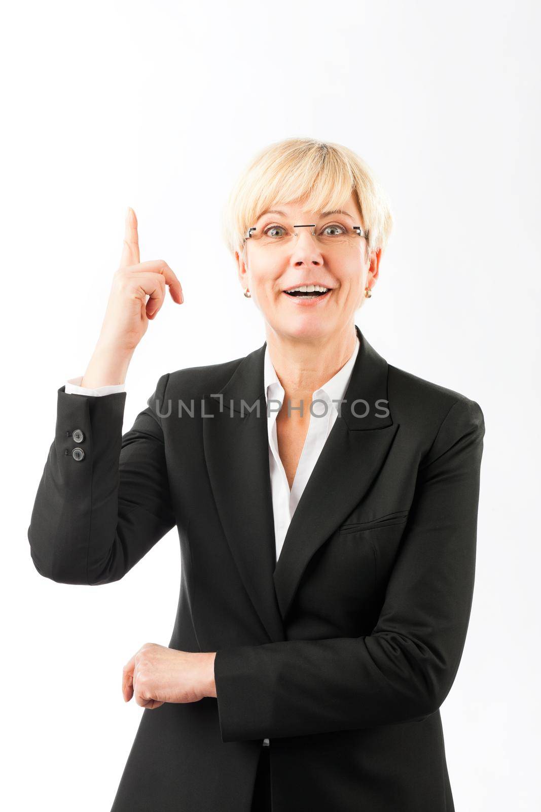 Portrait of happy mature businesswoman pointing finger upward against white background