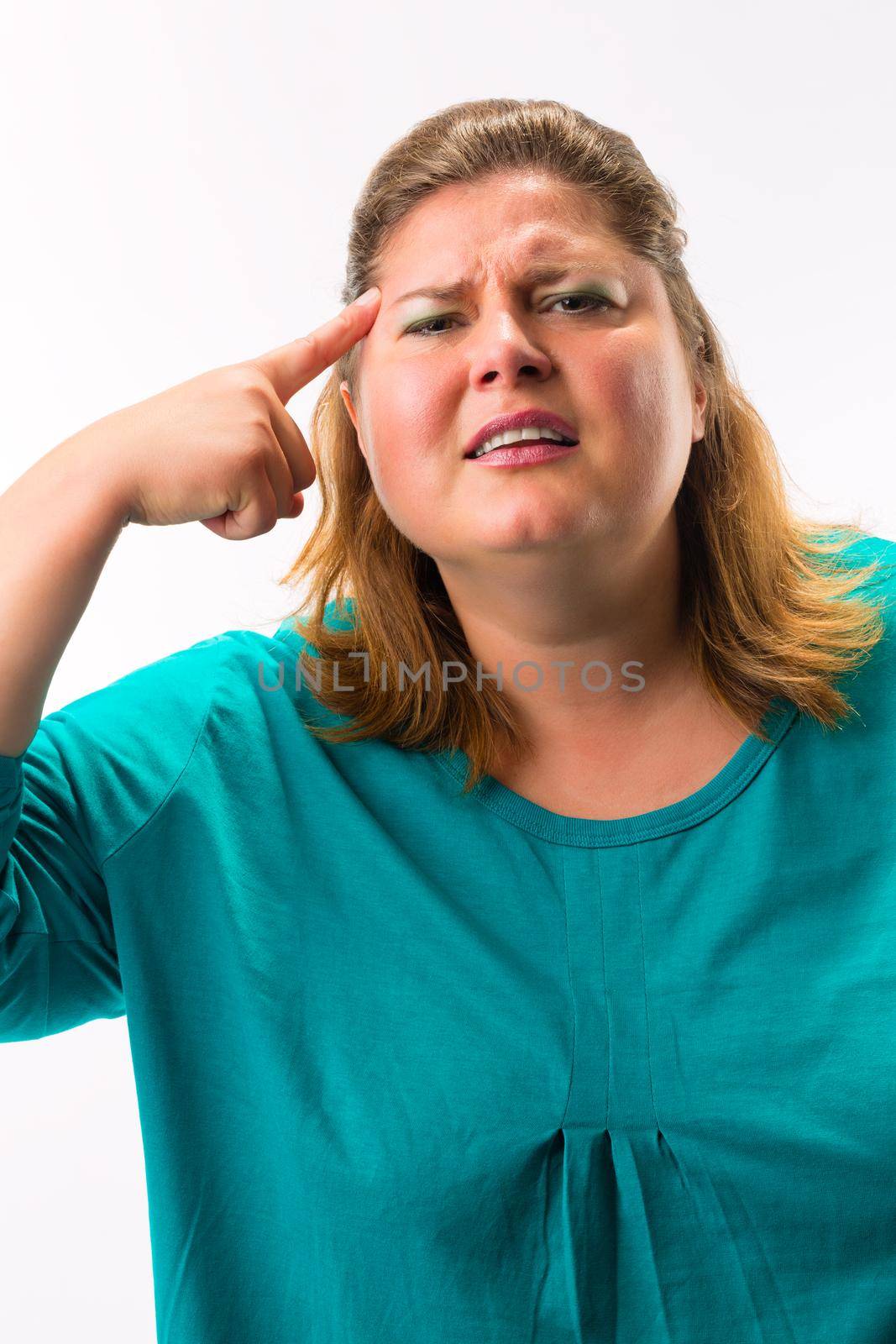 Fatty woman having headache touching finger on his forehead against white background