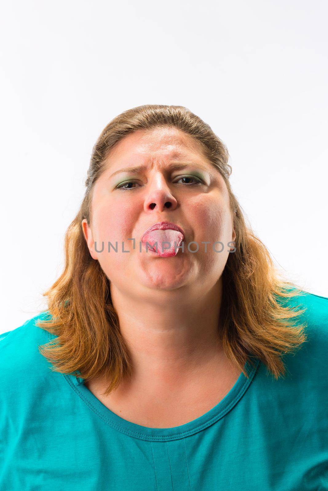 Close-up of woman showing her tongue against white background