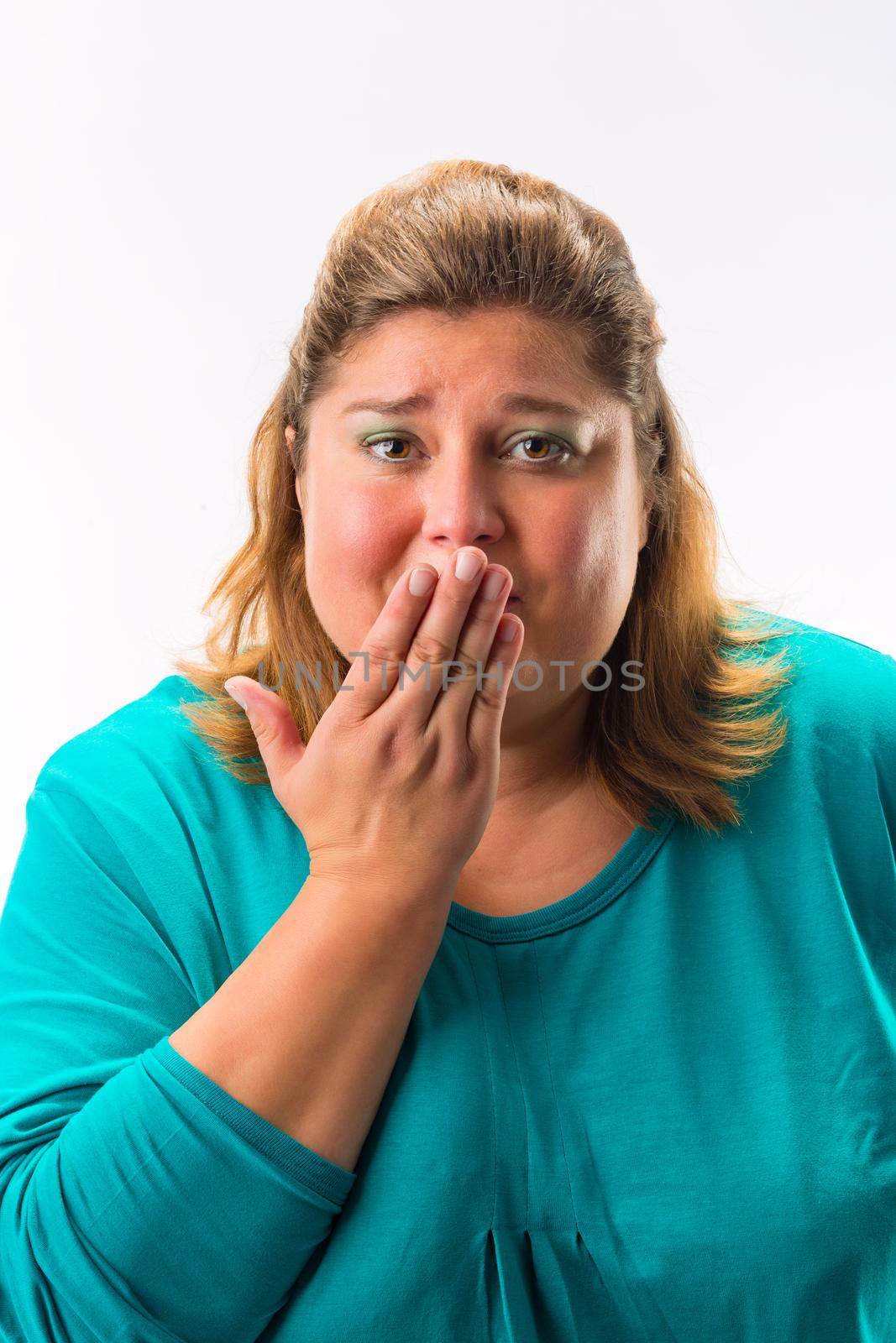 Worried woman with her hand over mouth isolated over white background