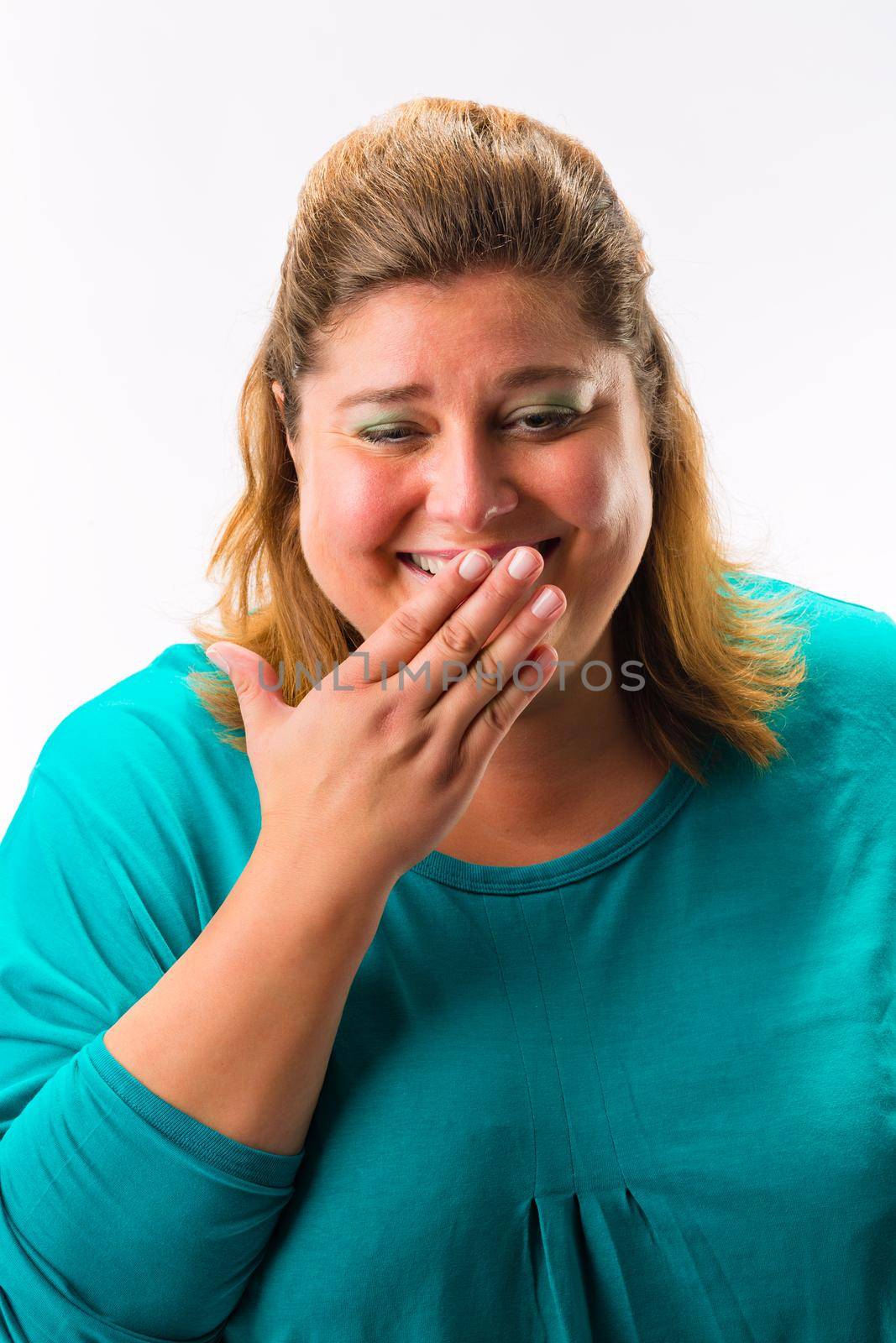 Portrait of fat happy woman laughing against white background