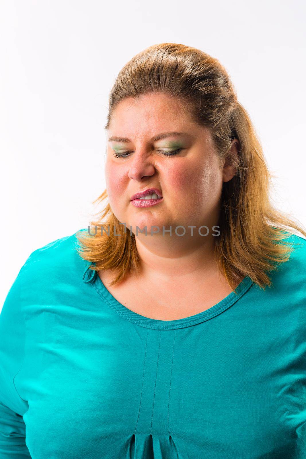 Portrait of an angry fatty woman making face isolated over white background