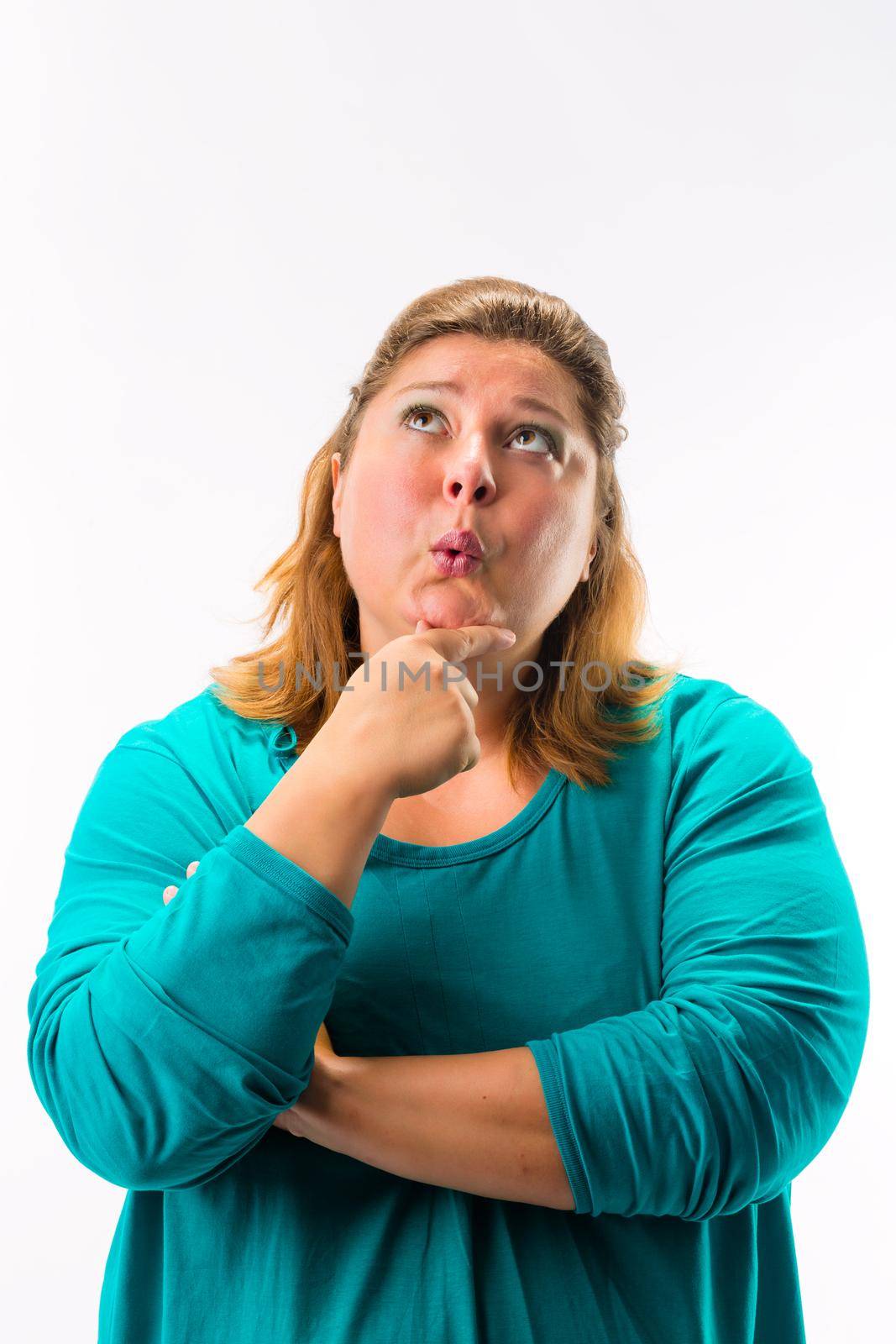 Close-up of contemplating young woman looking up against white backdrop