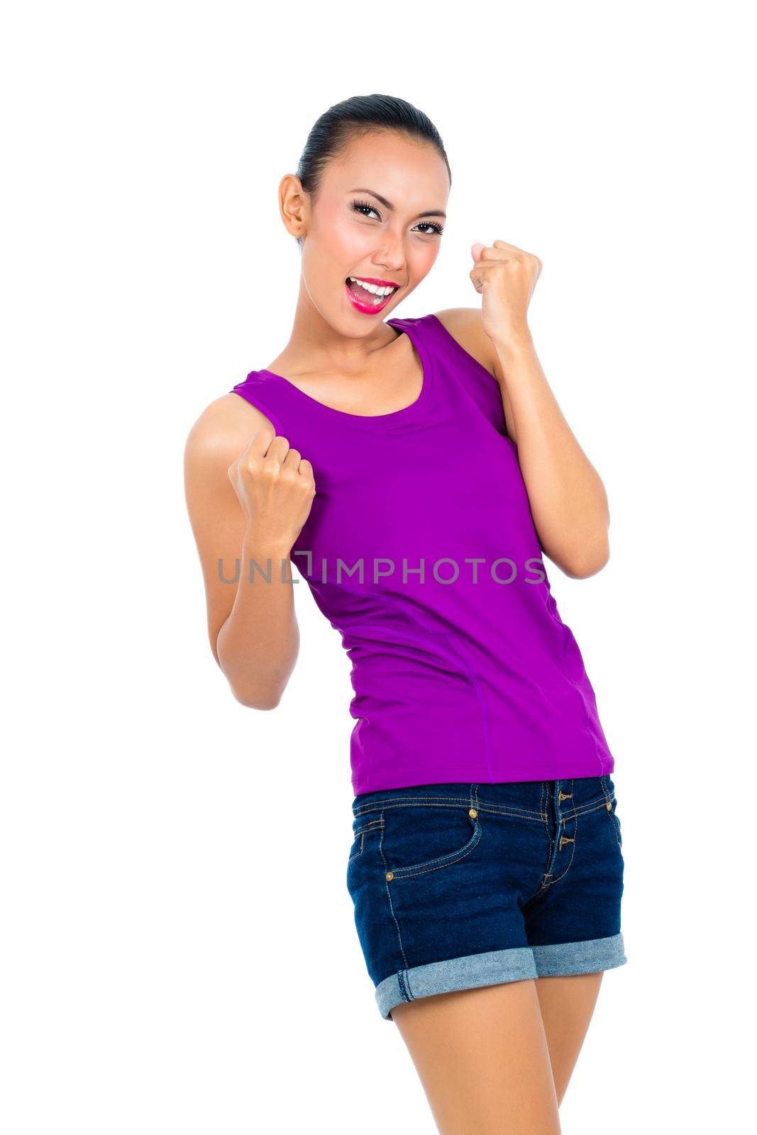 Happy woman clenching her fist over white background
