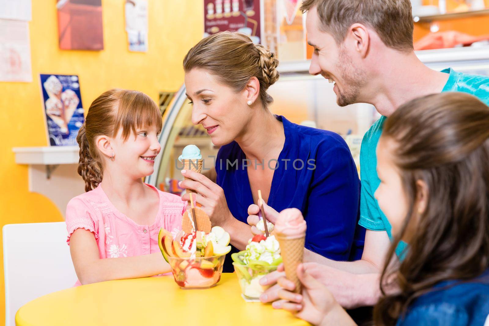 Family in ice cream parlor enjoying a sweet dessert