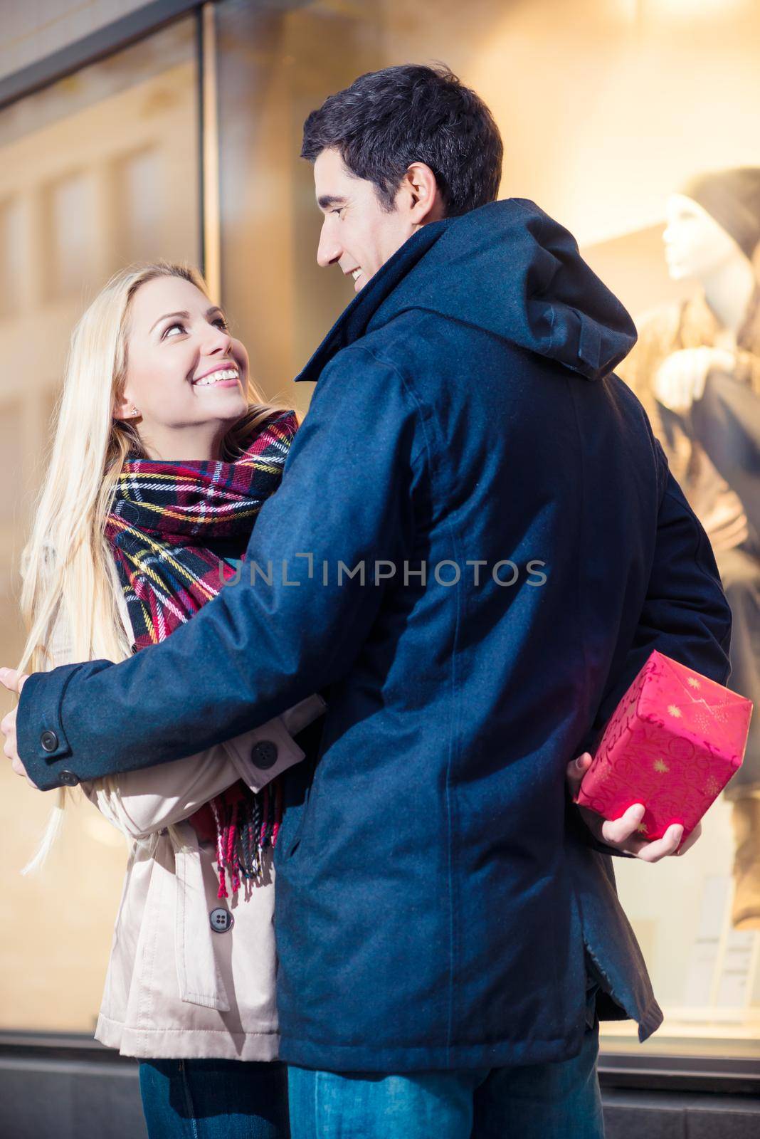 Happy couple looking at shopping window
