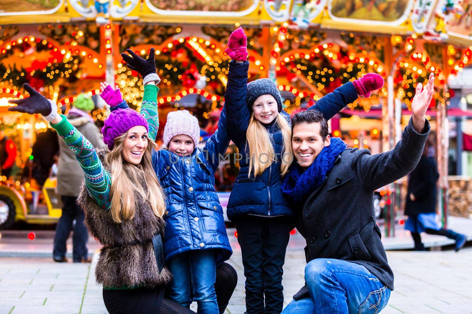 Cheerful family having fun on Christmas market