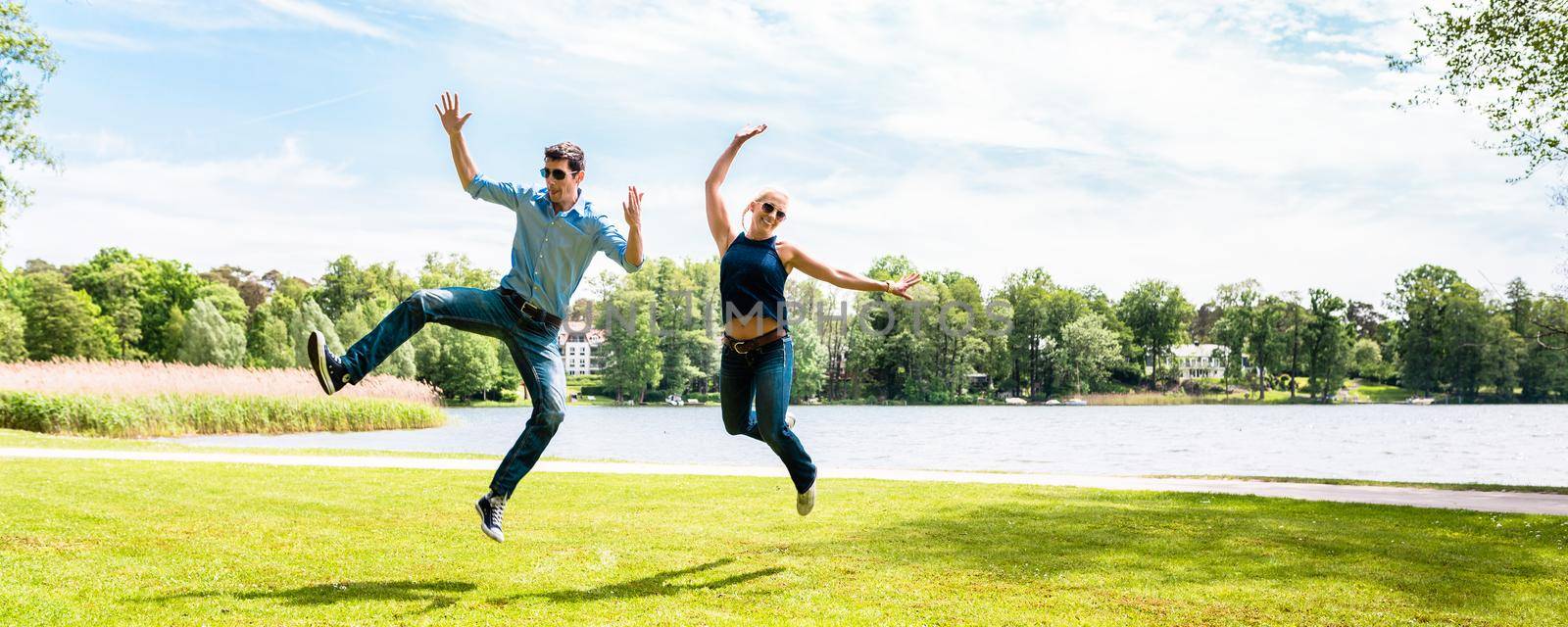 Young couple jumping in air by Kzenon