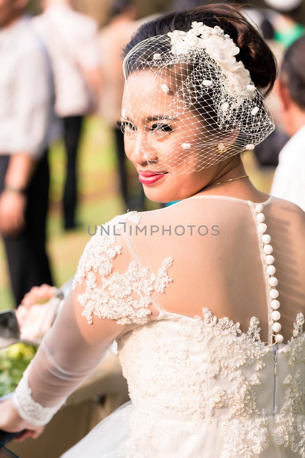Happy Indonesian bride on her wedding looking into camera
