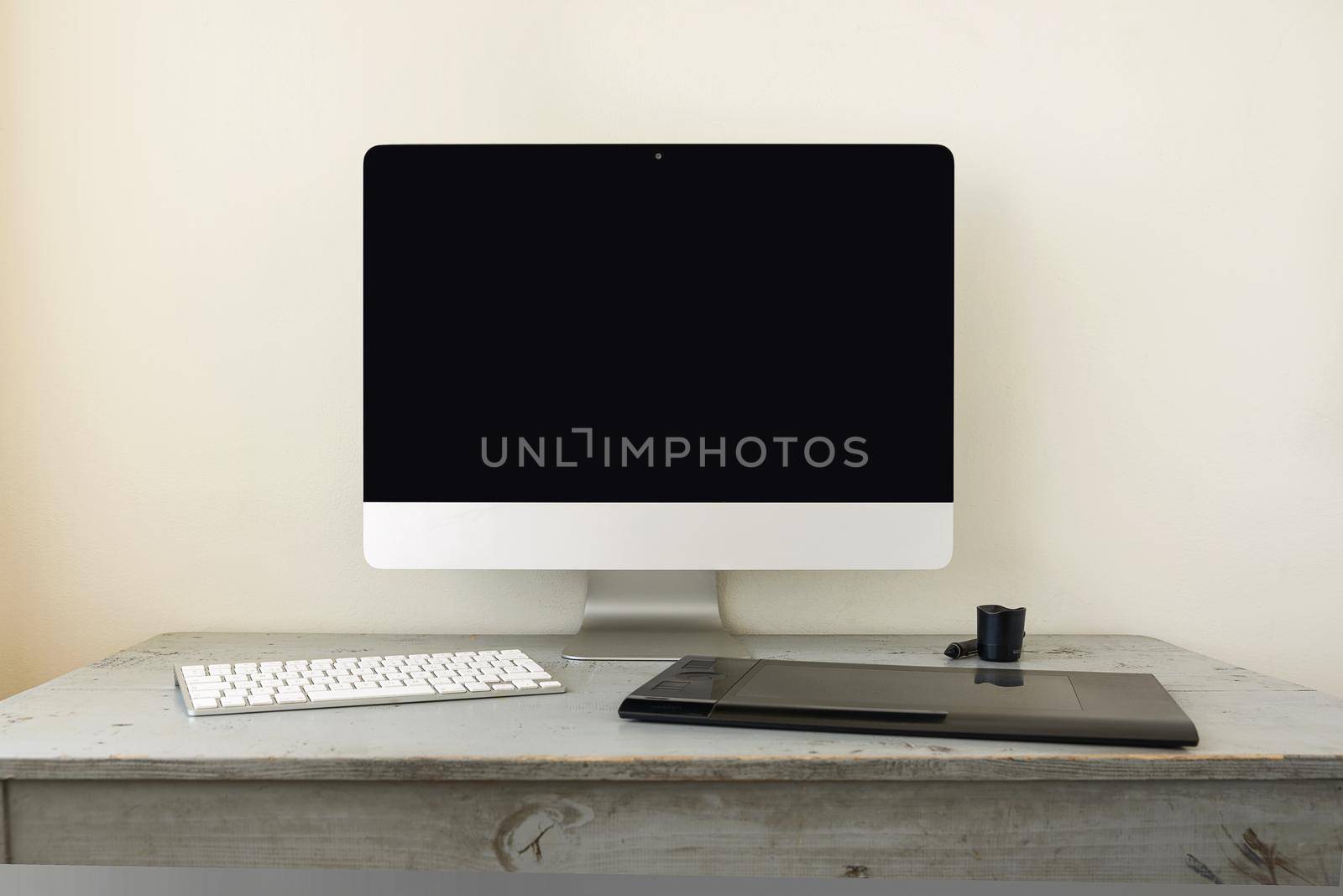 Computer with Keyboard and Graphic Tablet on Wooden Table and Space for Copy.