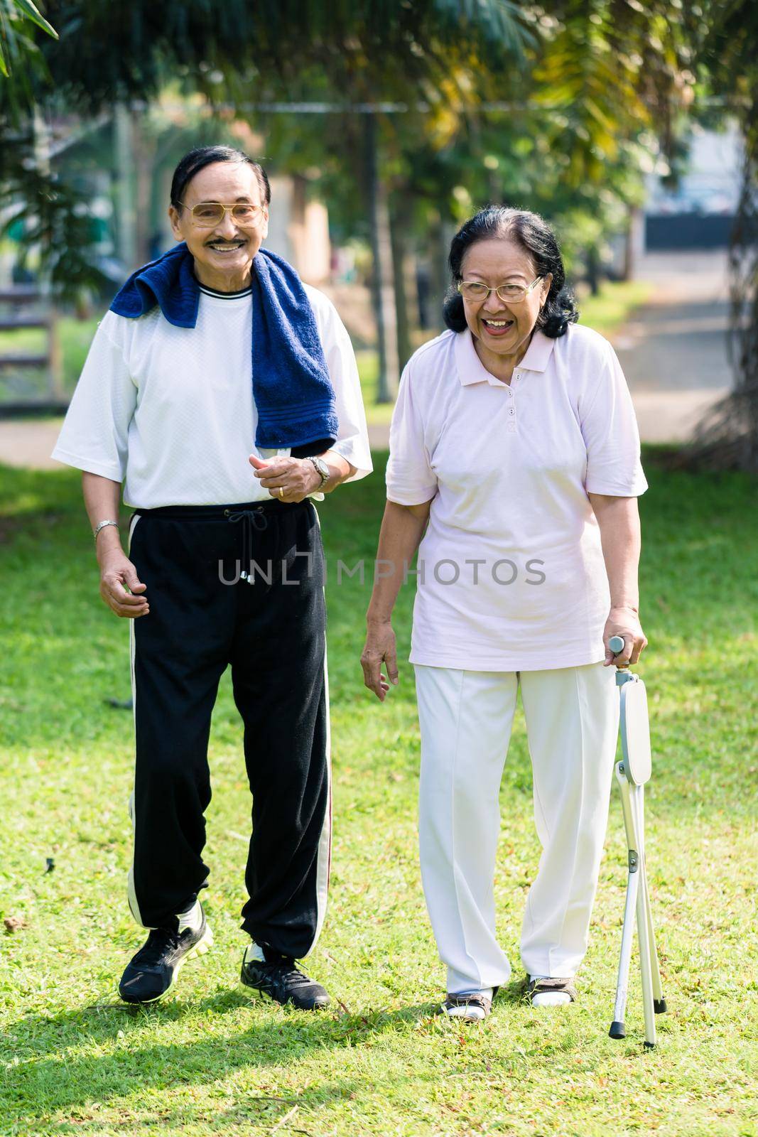 Senior couple walking in the park by Kzenon
