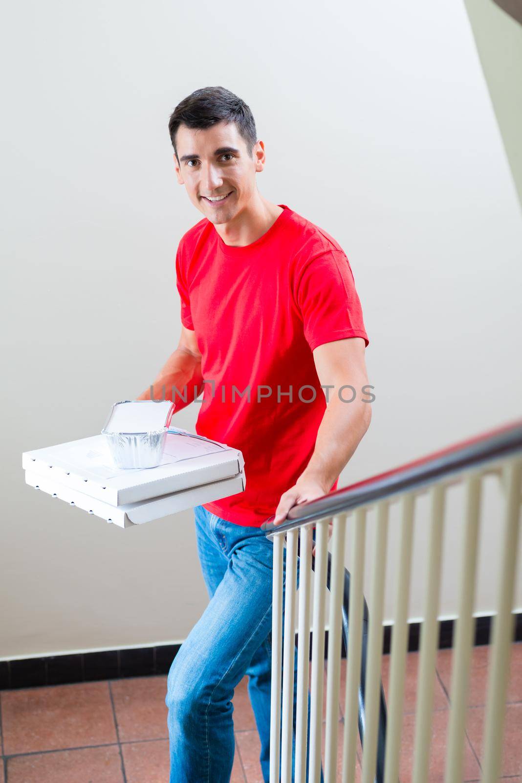 Portrait of smiling fast food delivery man with parcel