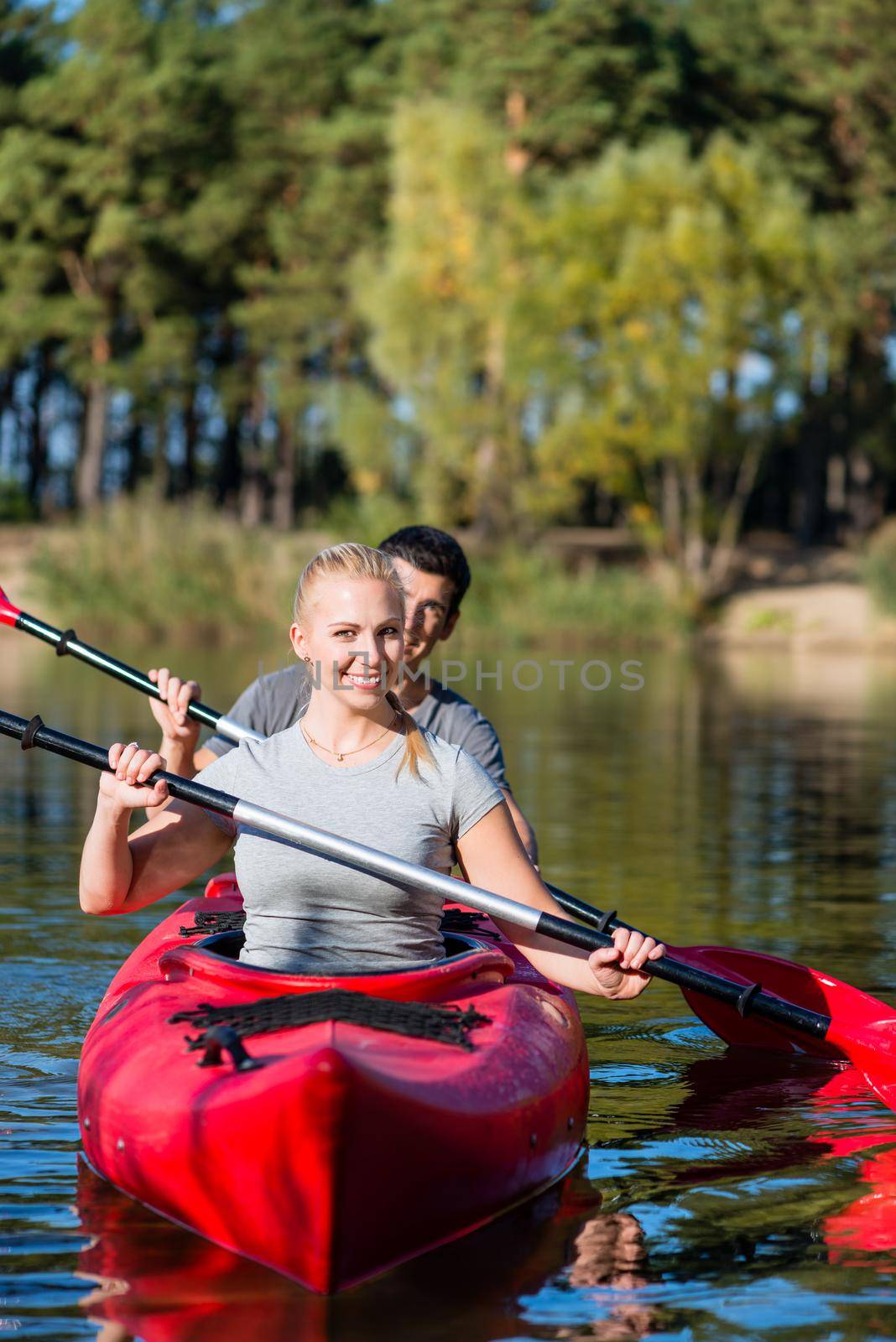 Portrait of happy couple kayaking on lake