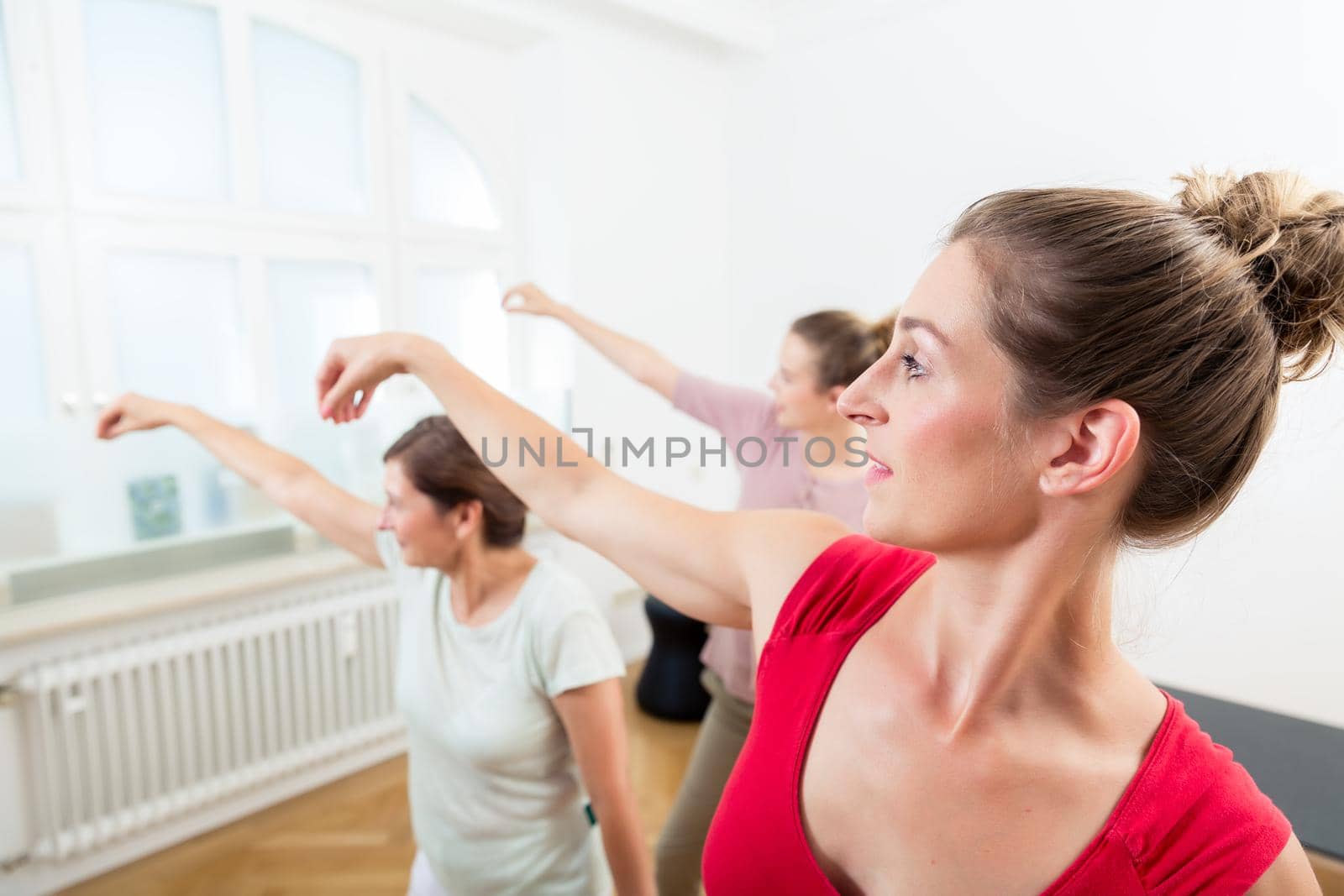 Group of female friends practicing yoga