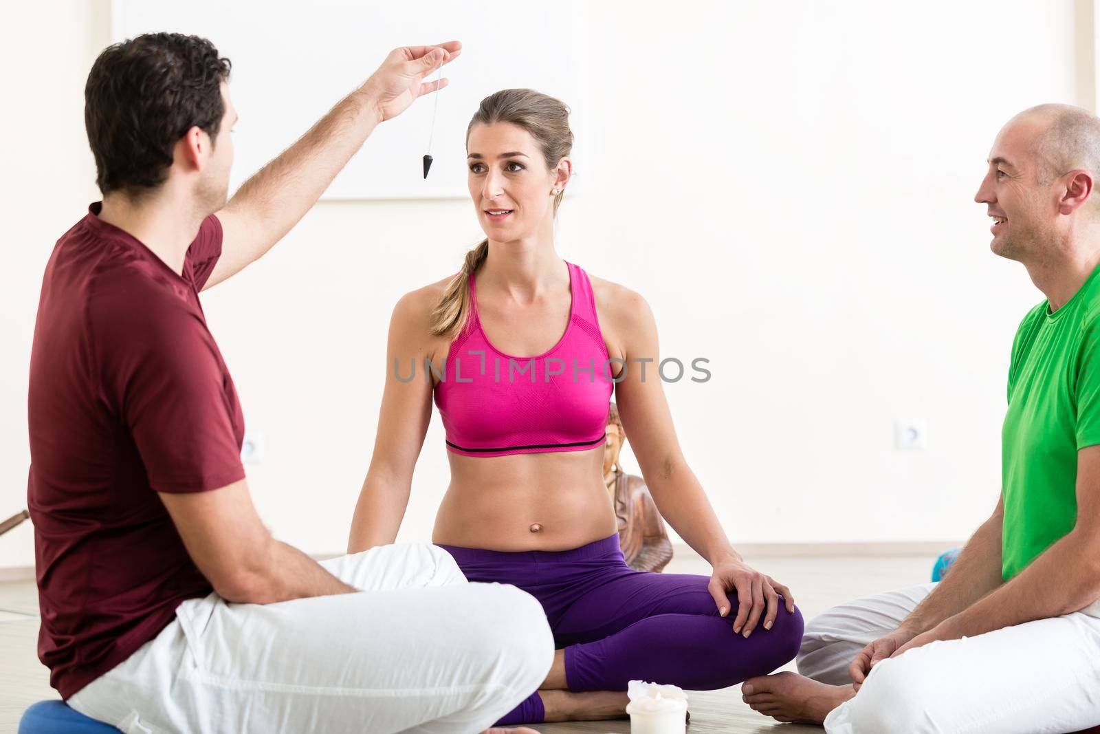 Young woman getting hypnotized by man by Kzenon