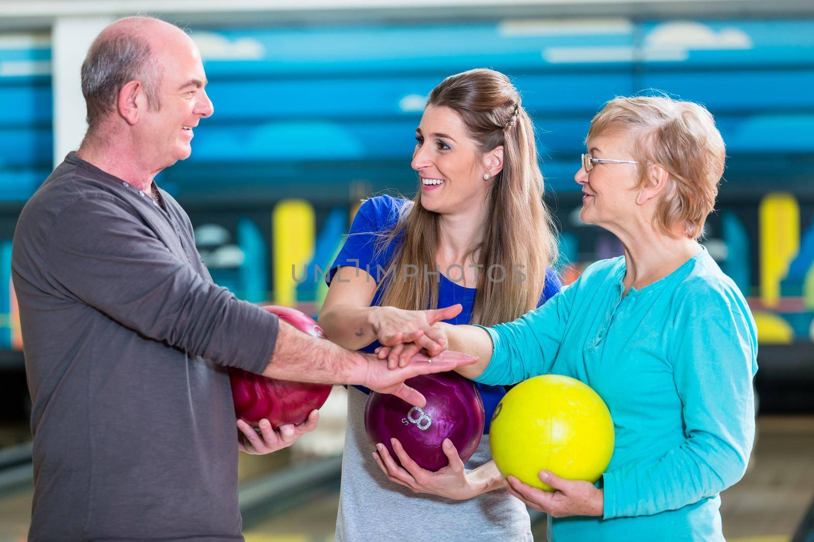 Smiling family stacking their hands while playing indoor games