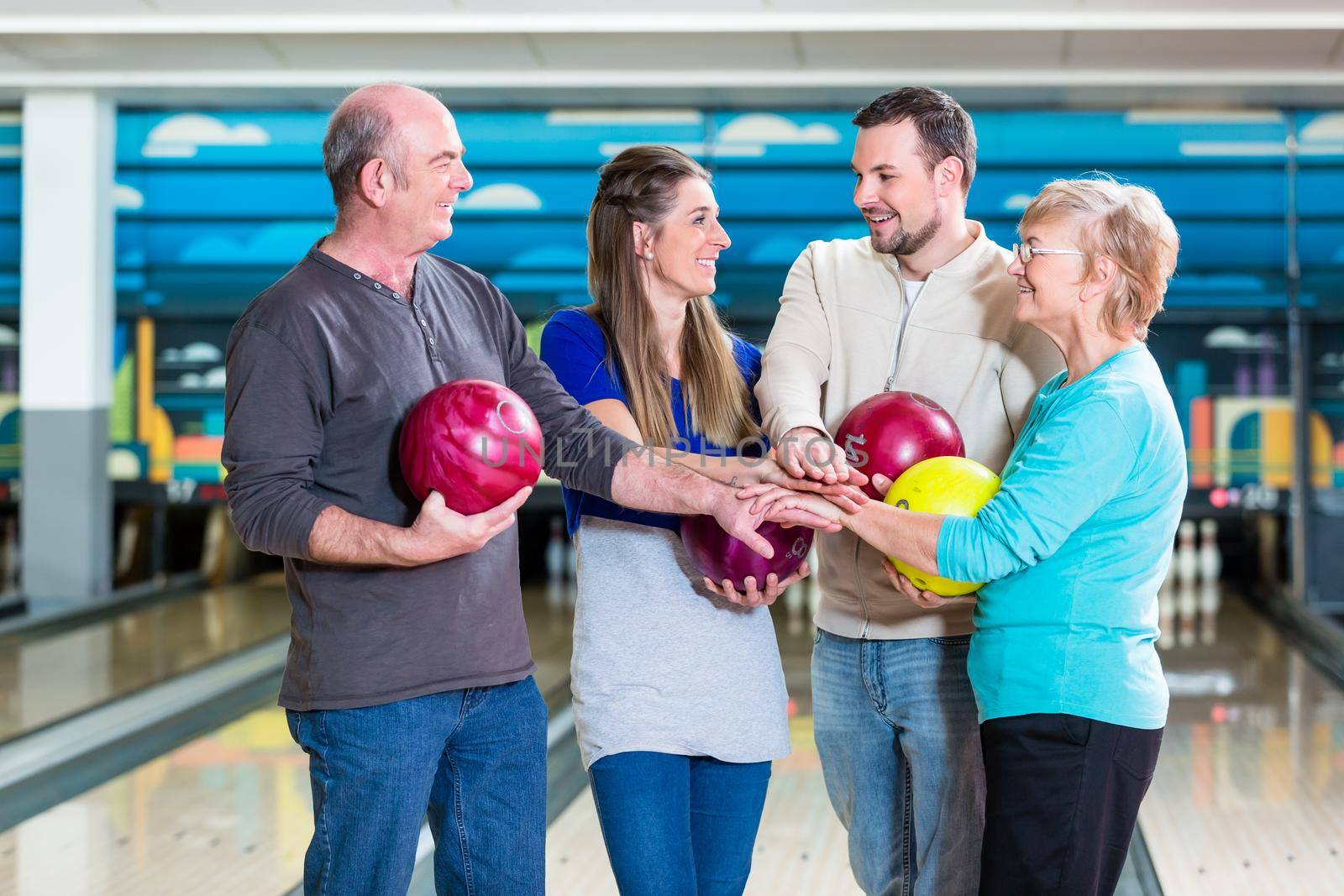 Portrait of smiling family stacking their hands